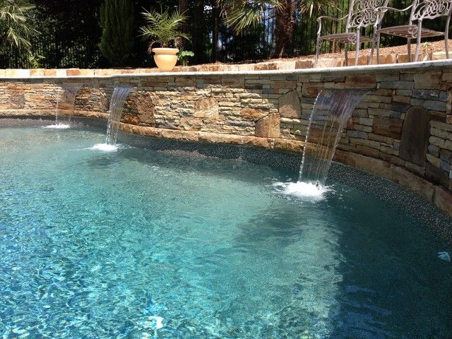 There is a waterfall in the middle of the pool
