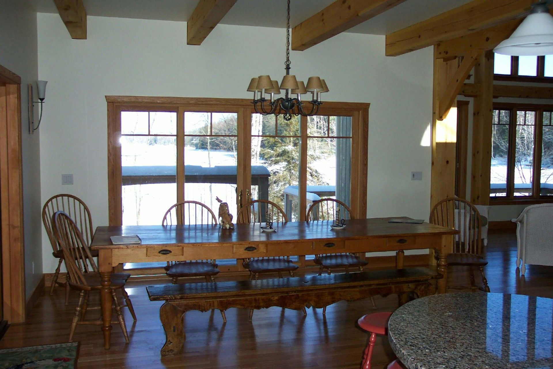 A dining room with a table and chairs and a chandelier