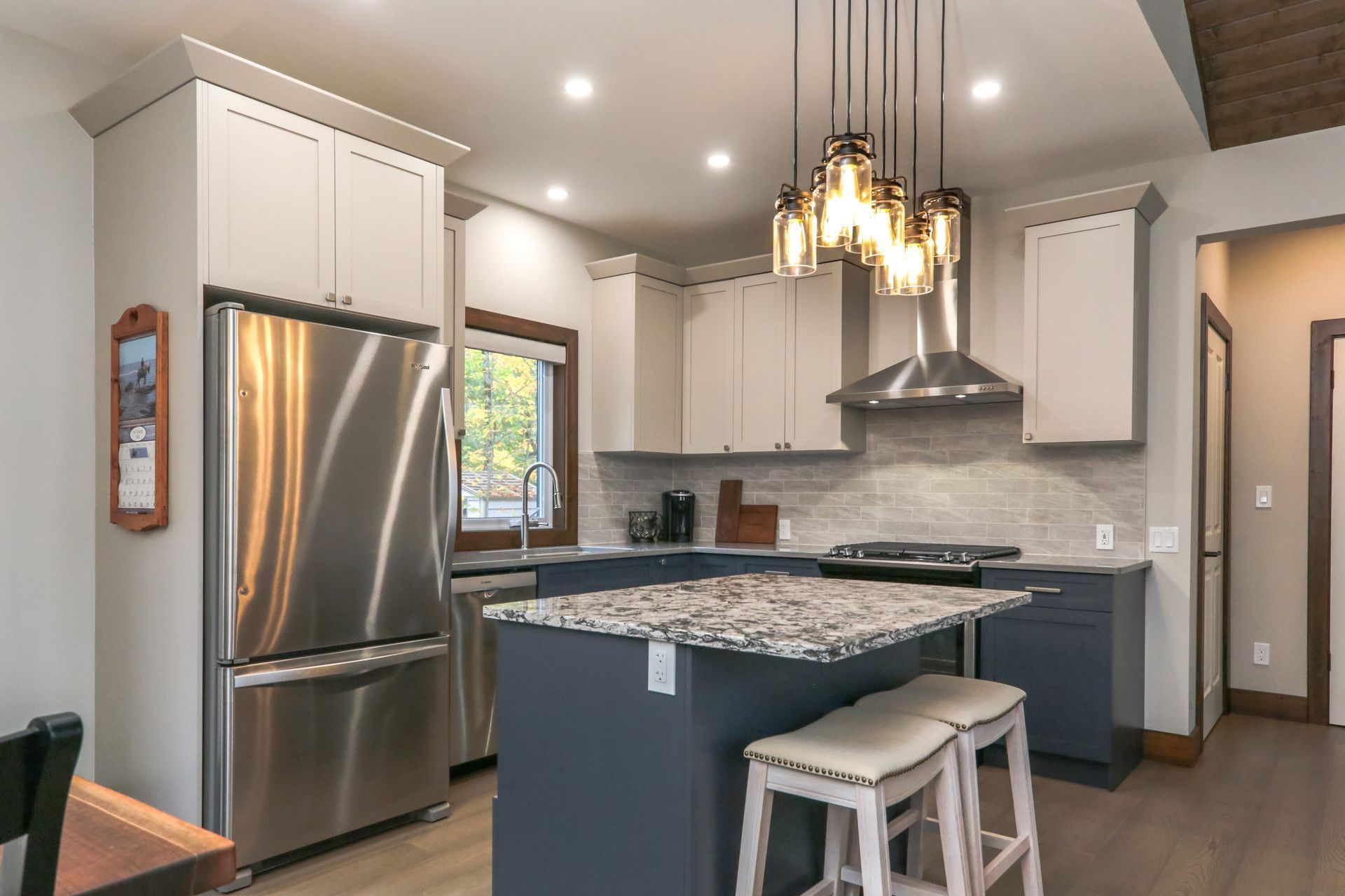 A kitchen with stainless steel appliances and granite counter tops.