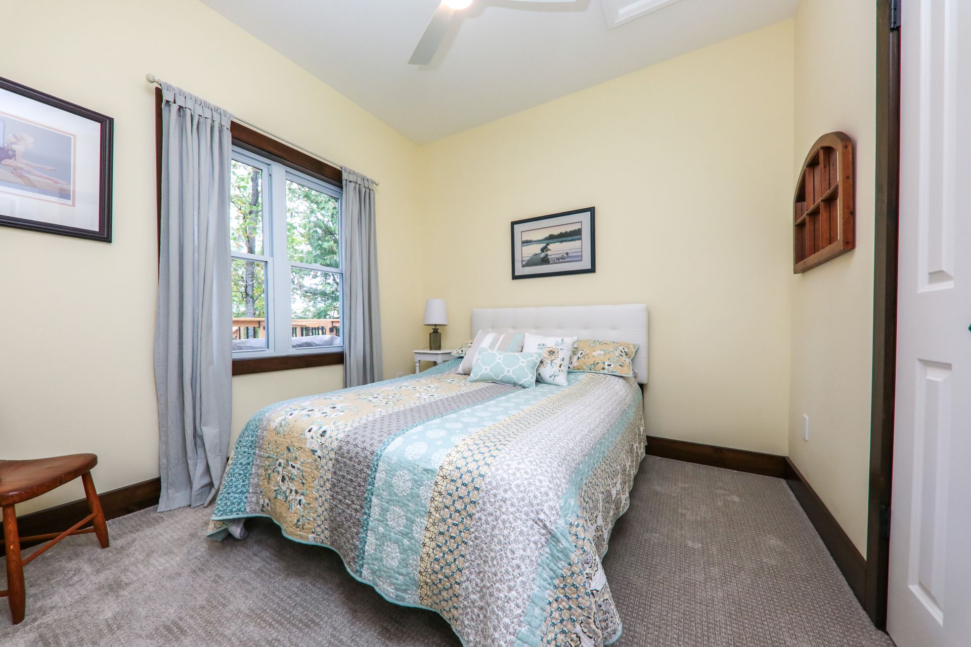A bedroom with a king size bed and a ceiling fan.