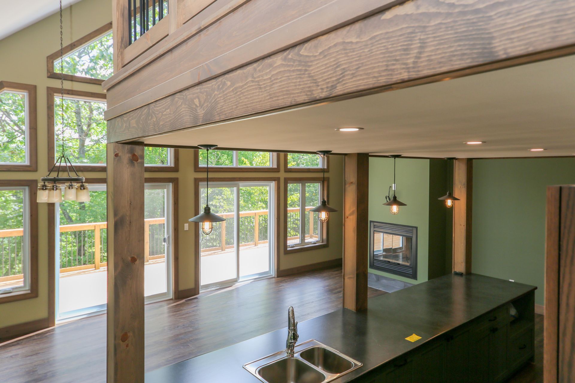 A kitchen with two sinks and a fireplace in a house.