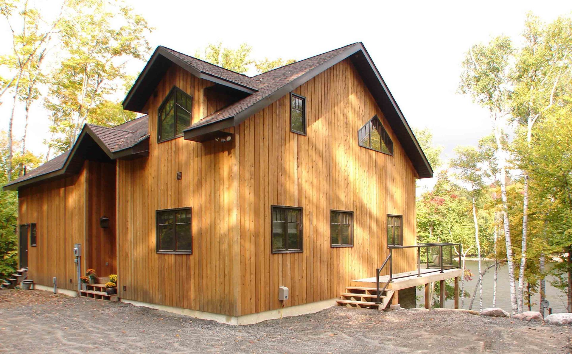 A large wooden house in the middle of a forest