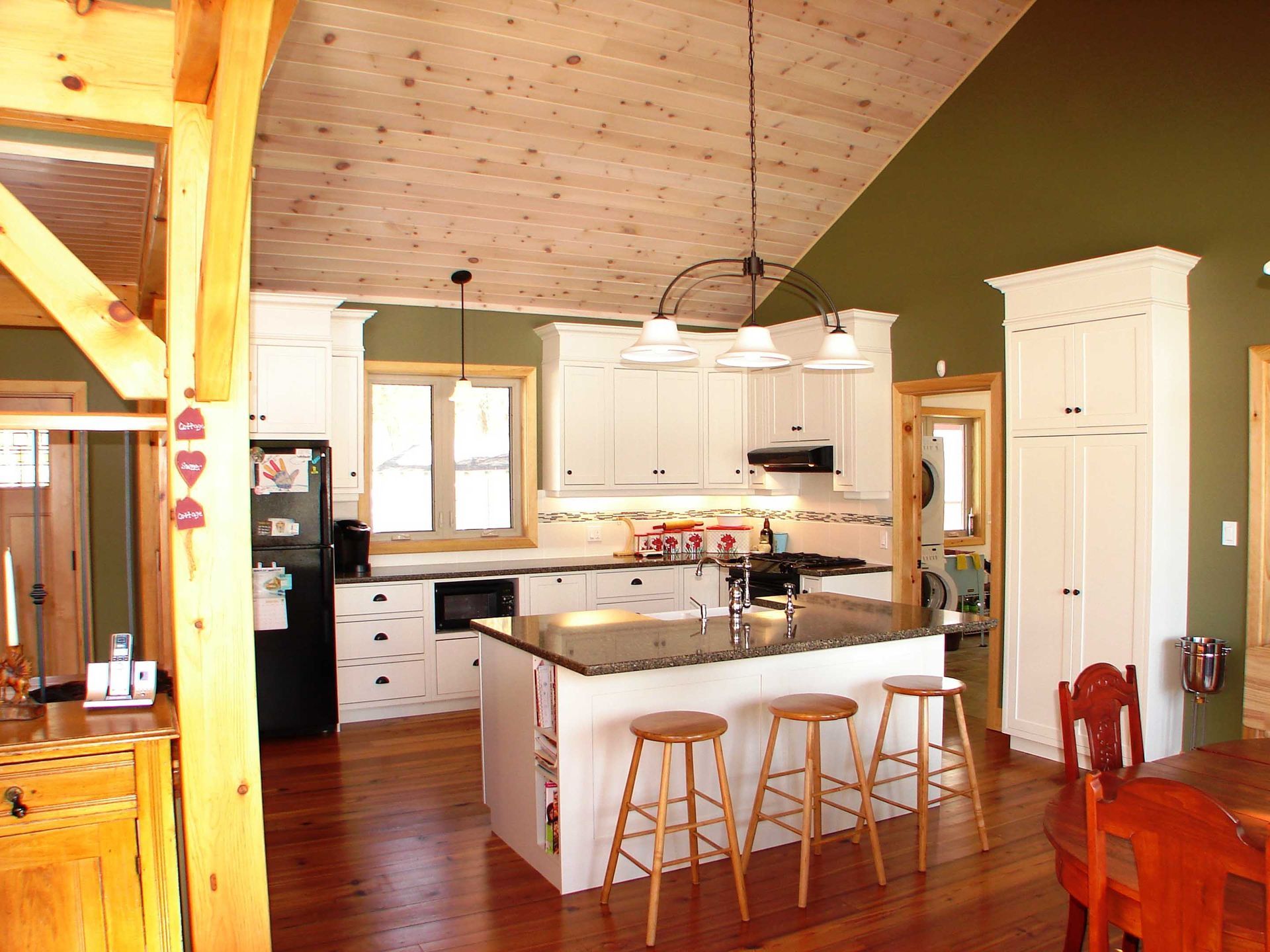 A kitchen with white cabinets and a large island