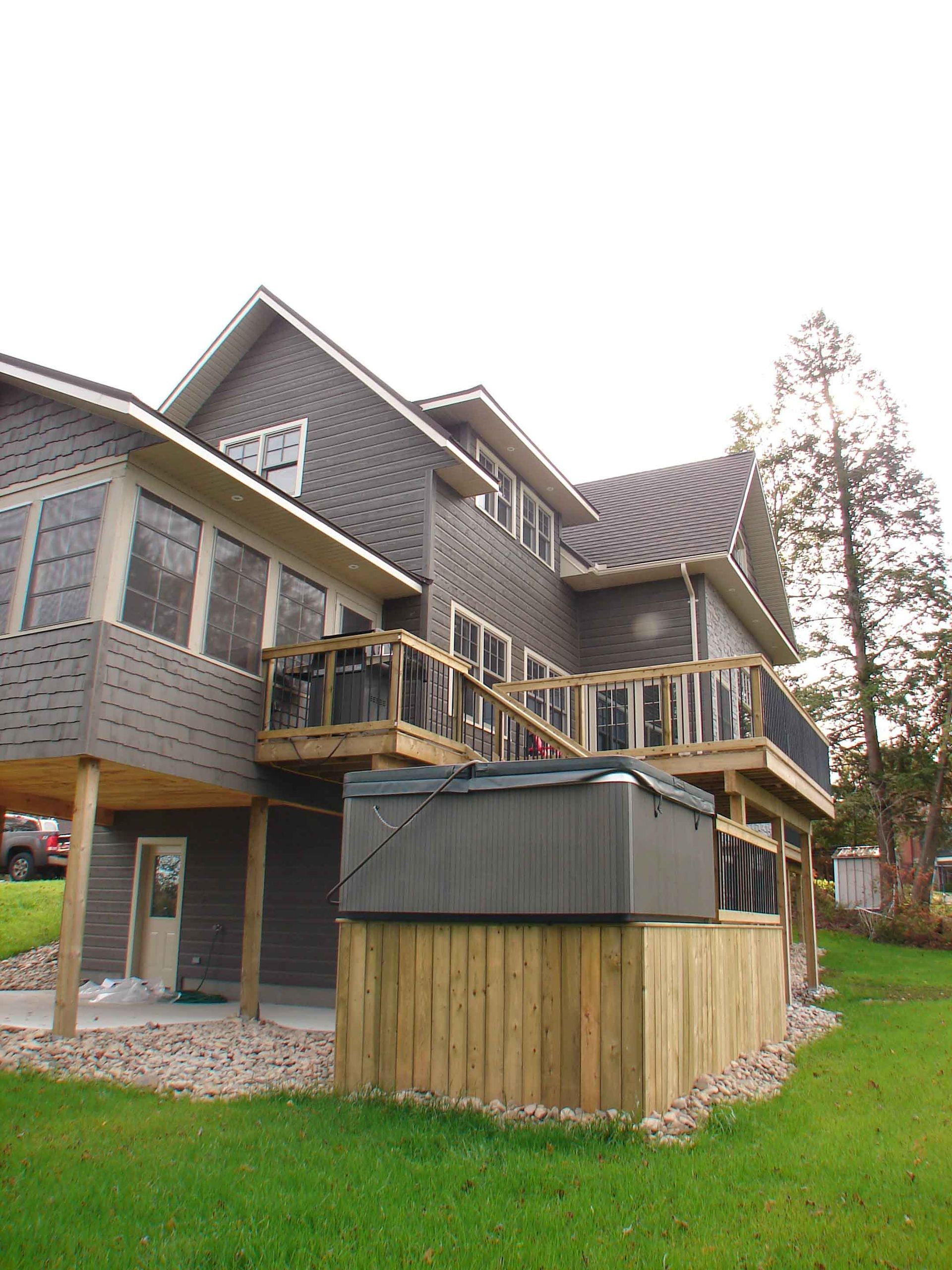 A large house with a hot tub in front of it