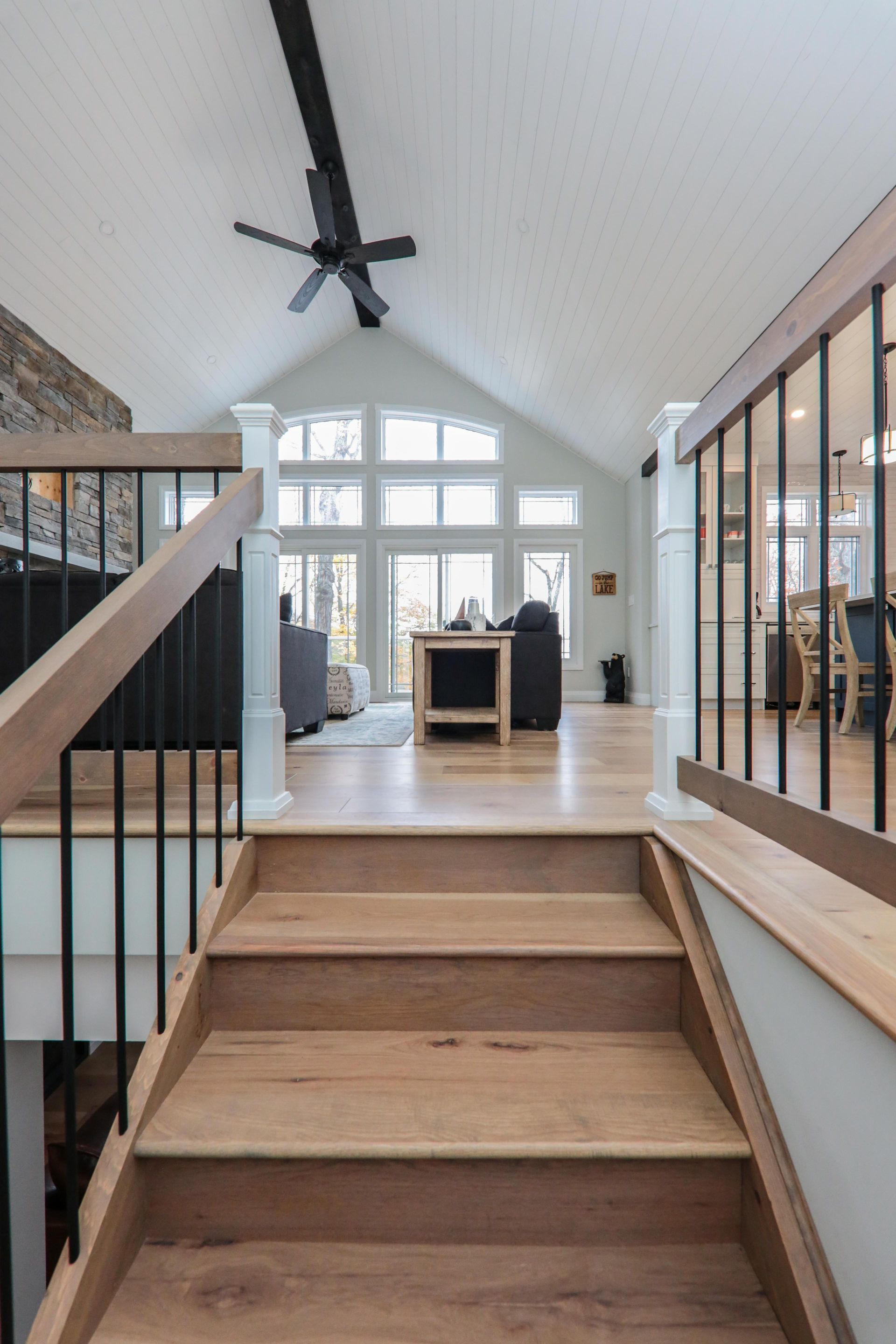 A wooden staircase leading up to a living room in a house.