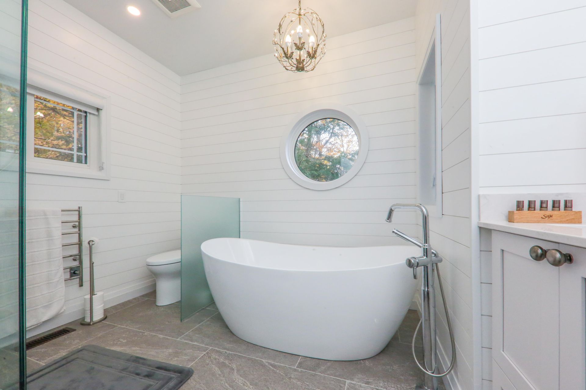 A bathroom with a tub , toilet , and shower.