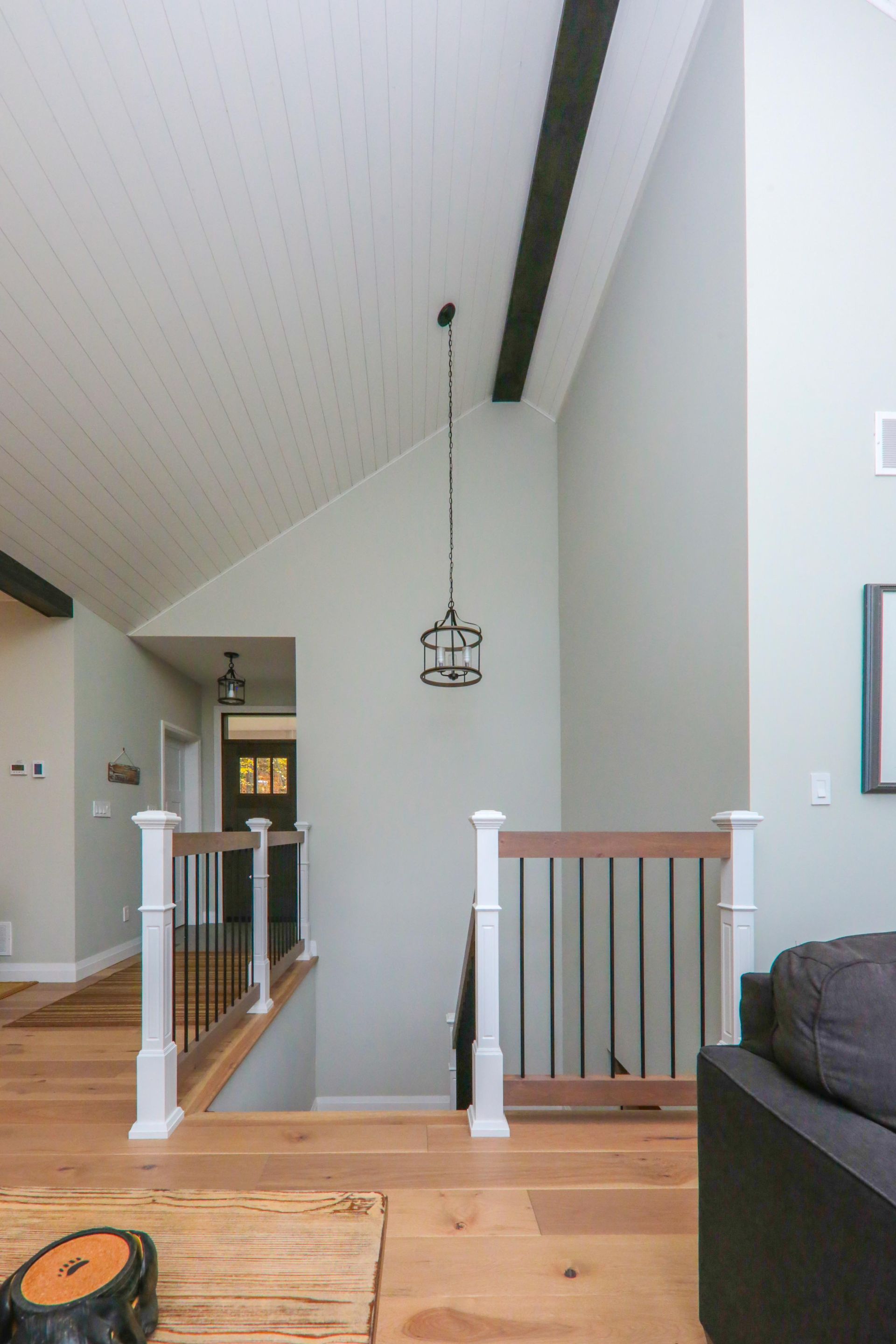 A living room with a staircase leading up to the second floor.
