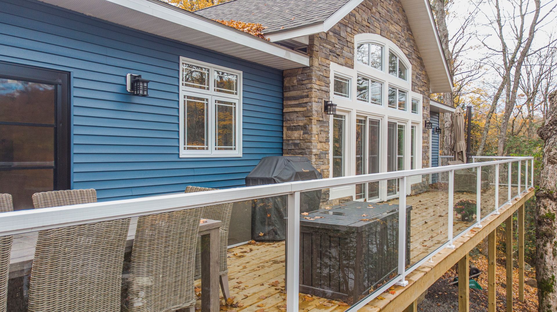 A large house with a large deck and a large window.