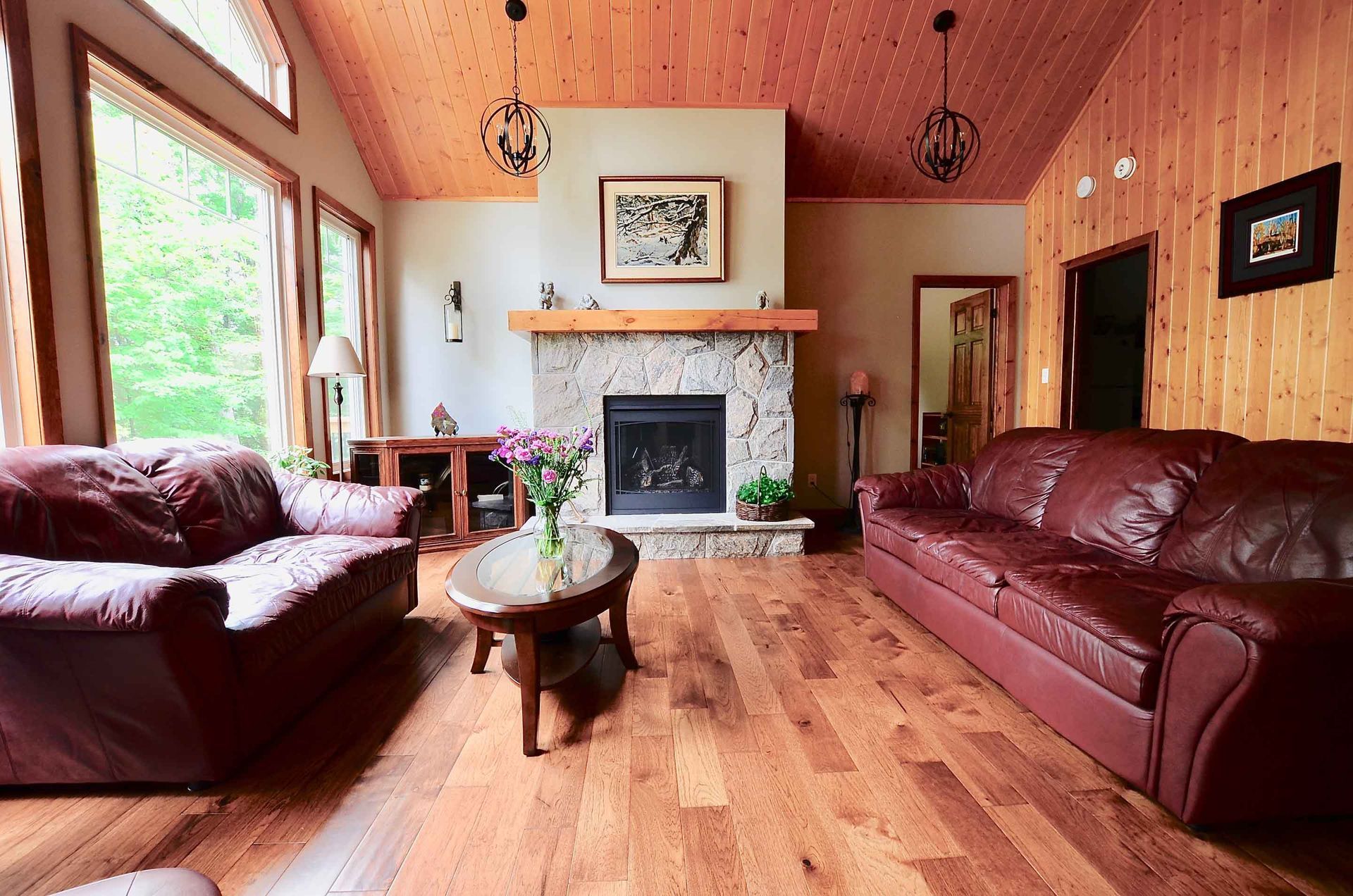 A living room with two couches and a fireplace.