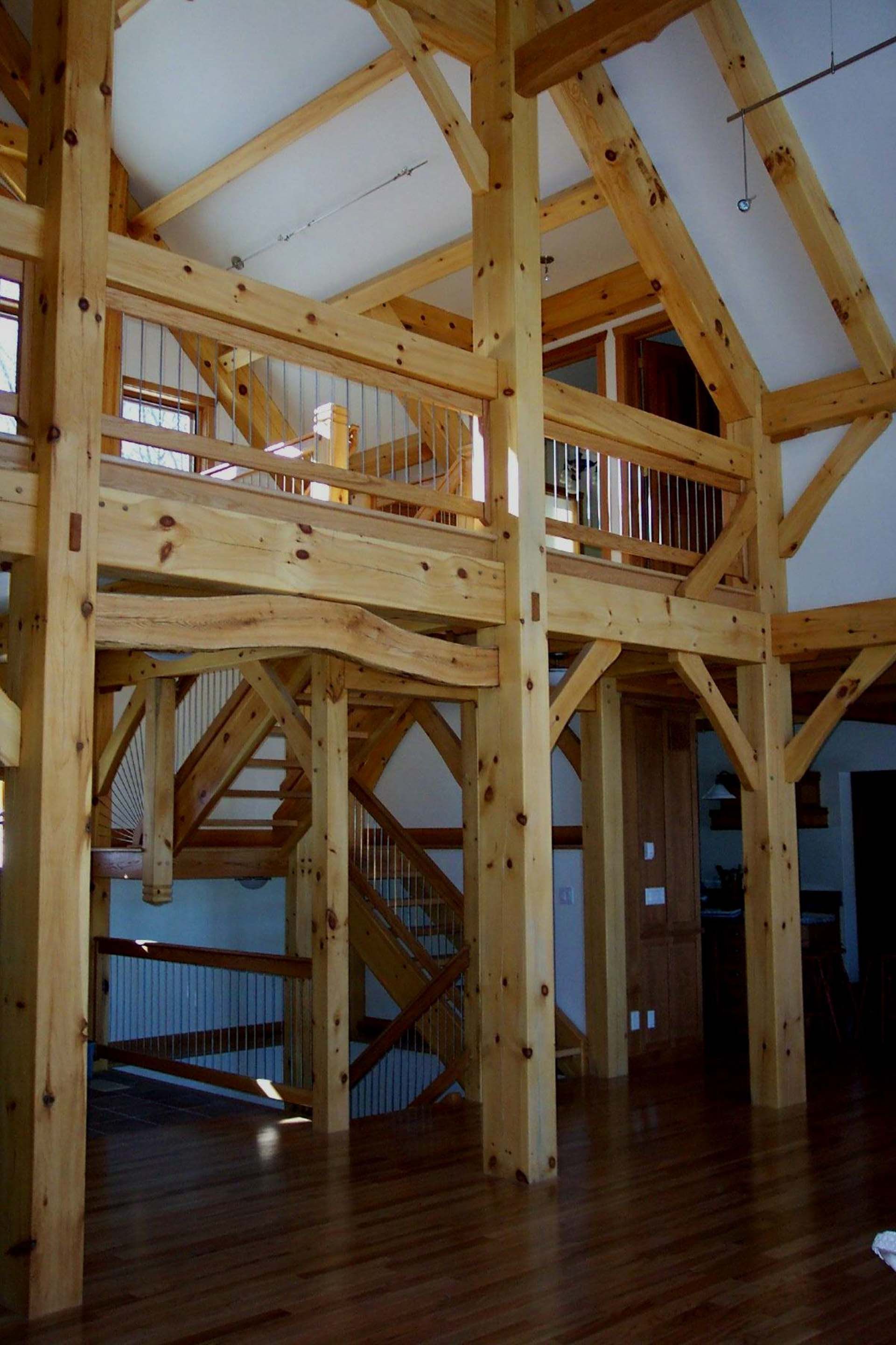 A large wooden structure with stairs and a balcony