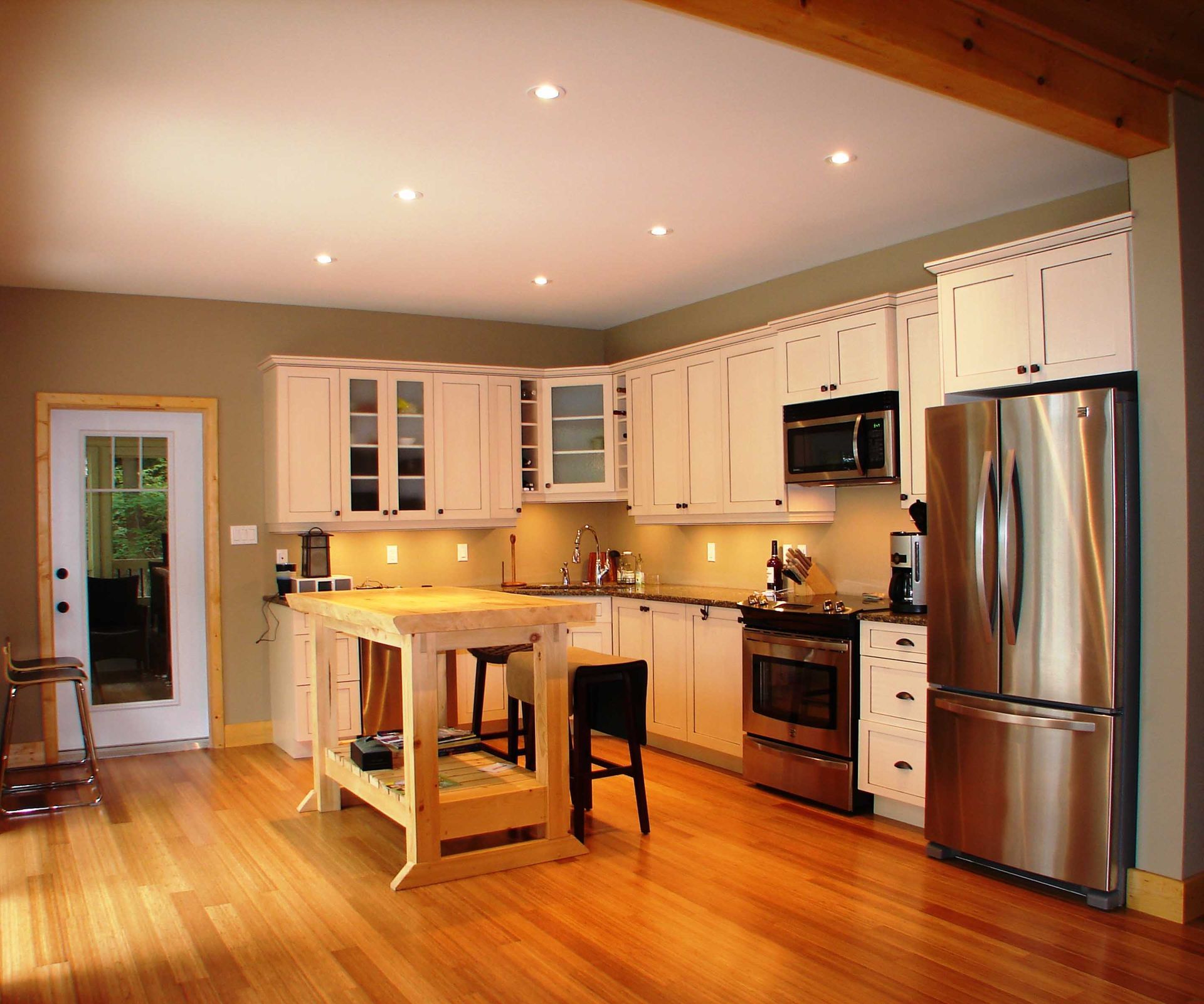 A kitchen with white cabinets and stainless steel appliances