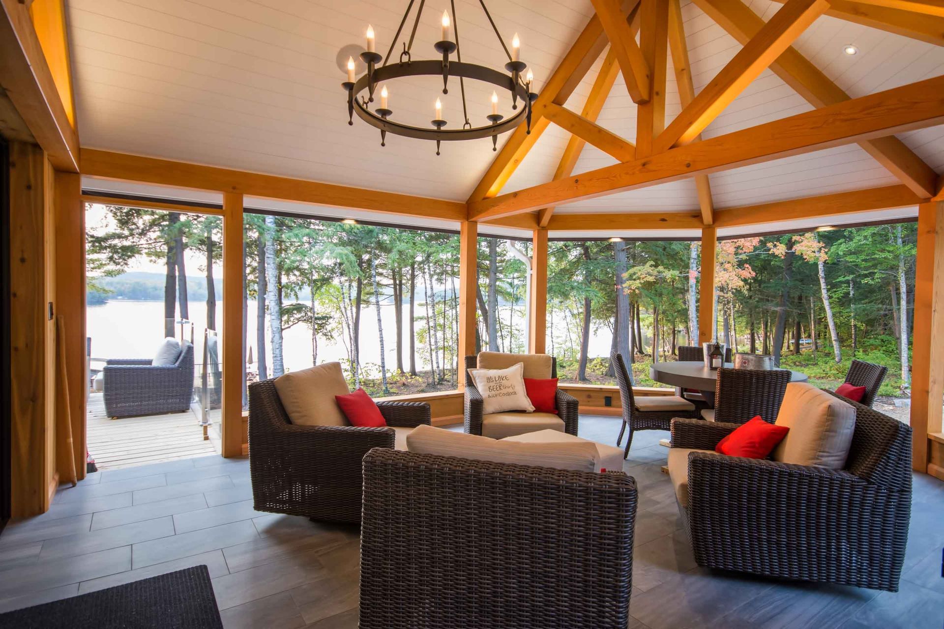 A living room with a lot of furniture and a chandelier hanging from the ceiling.