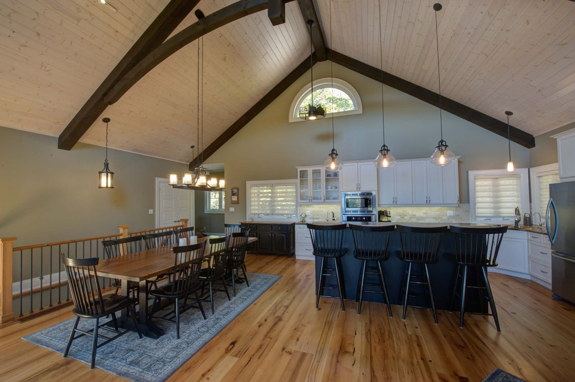 A kitchen and dining room in a house with a vaulted ceiling