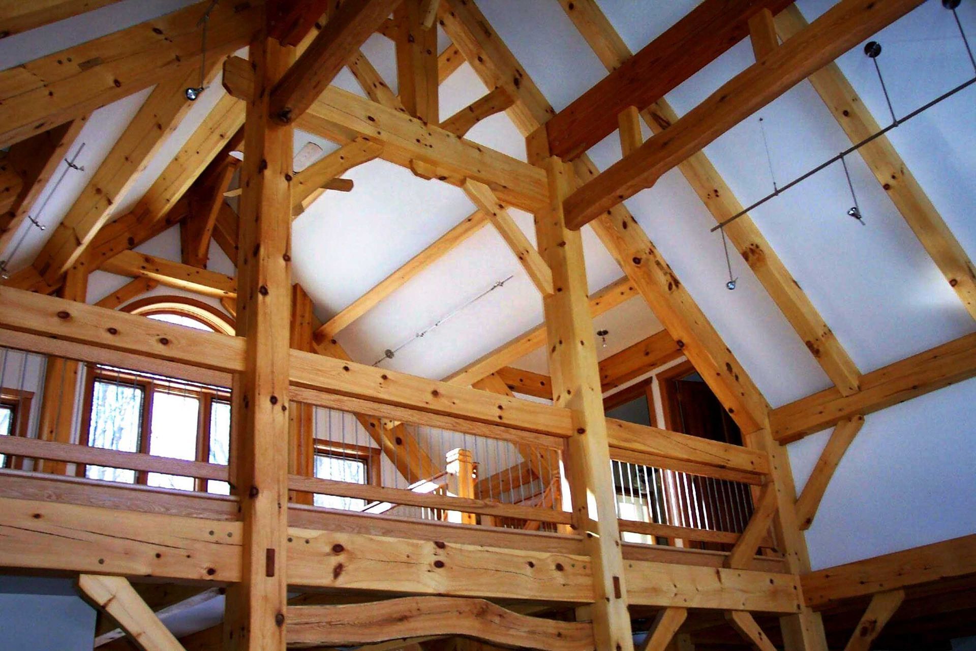 The inside of a wooden structure with a balcony