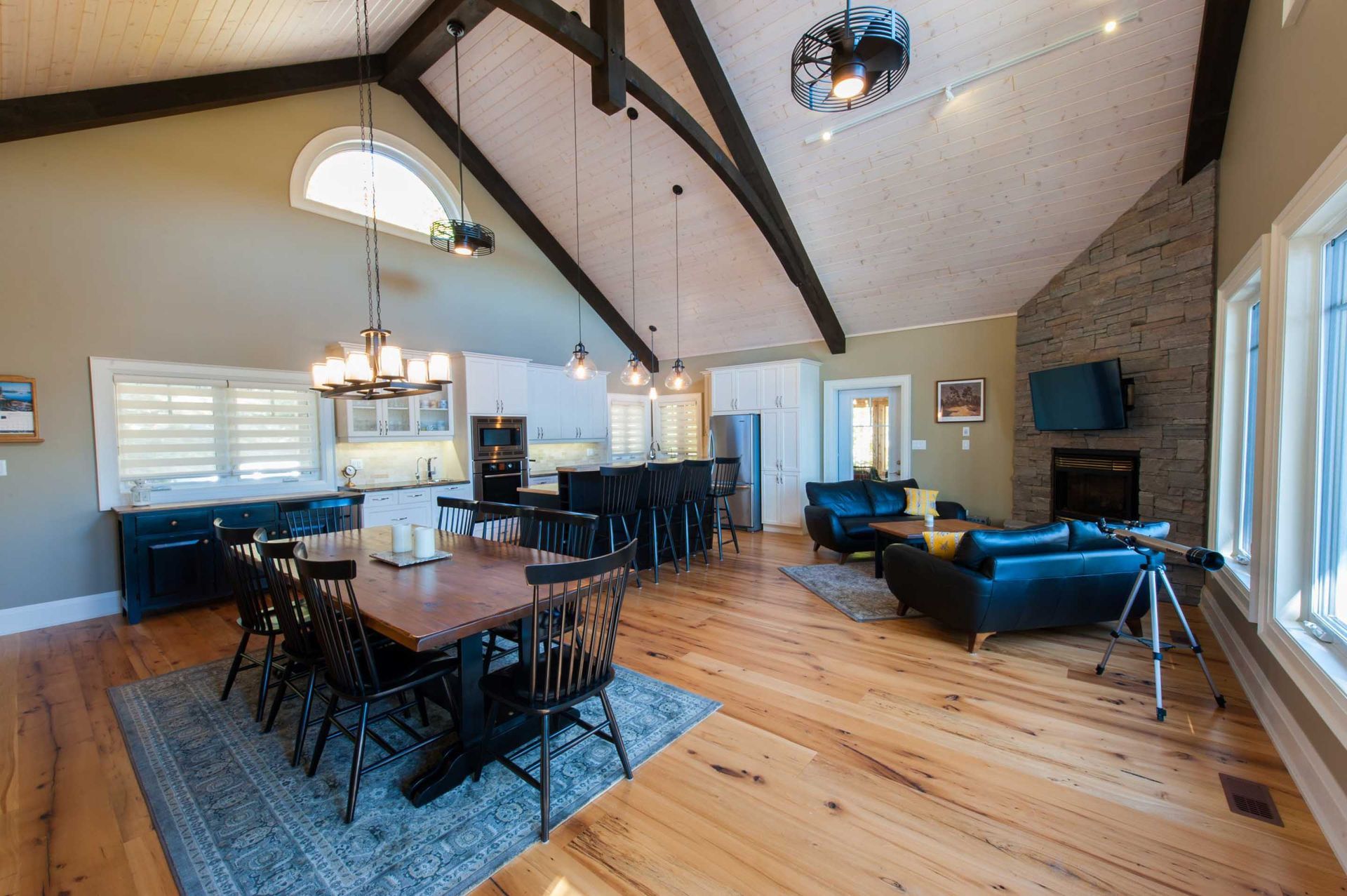 A large living room with a dining table and chairs