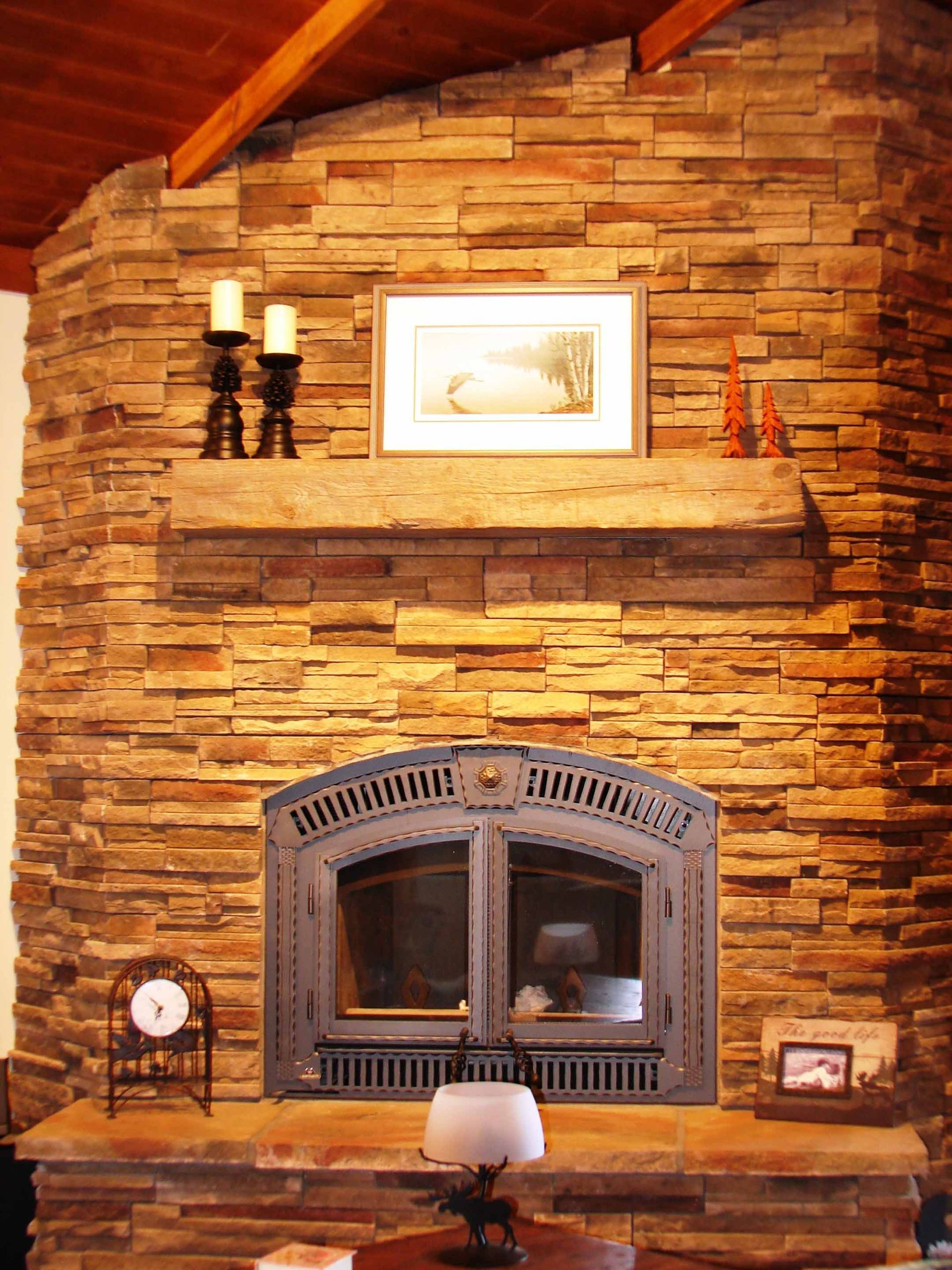 A fireplace with a picture above it and candles on it