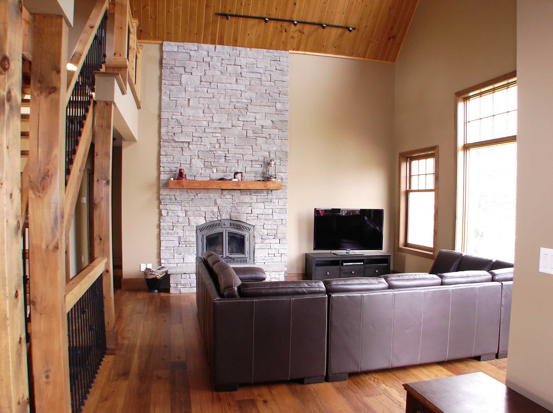 A living room with a couch a fireplace and a flat screen tv
