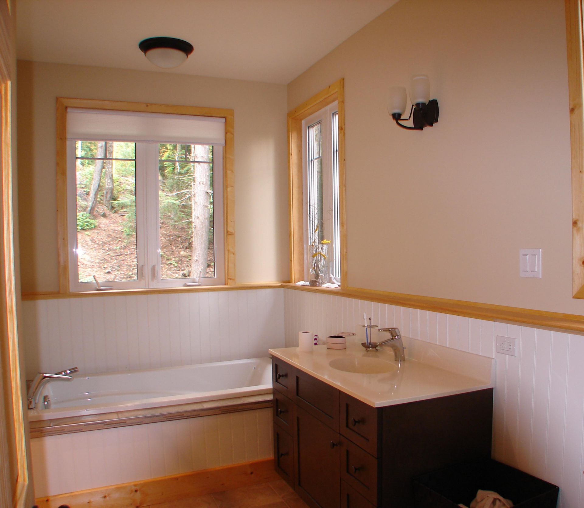 A bathroom with a tub sink and window