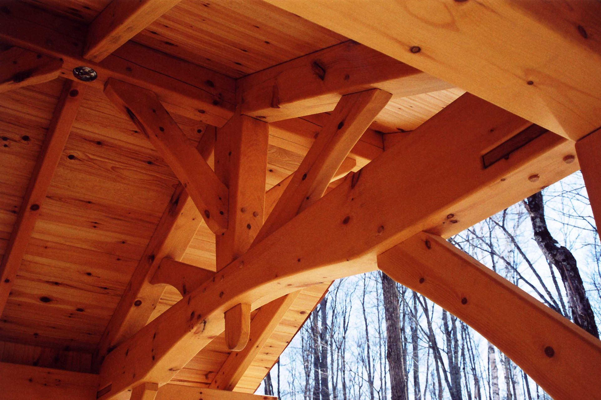 A close up of a wooden structure with trees in the background