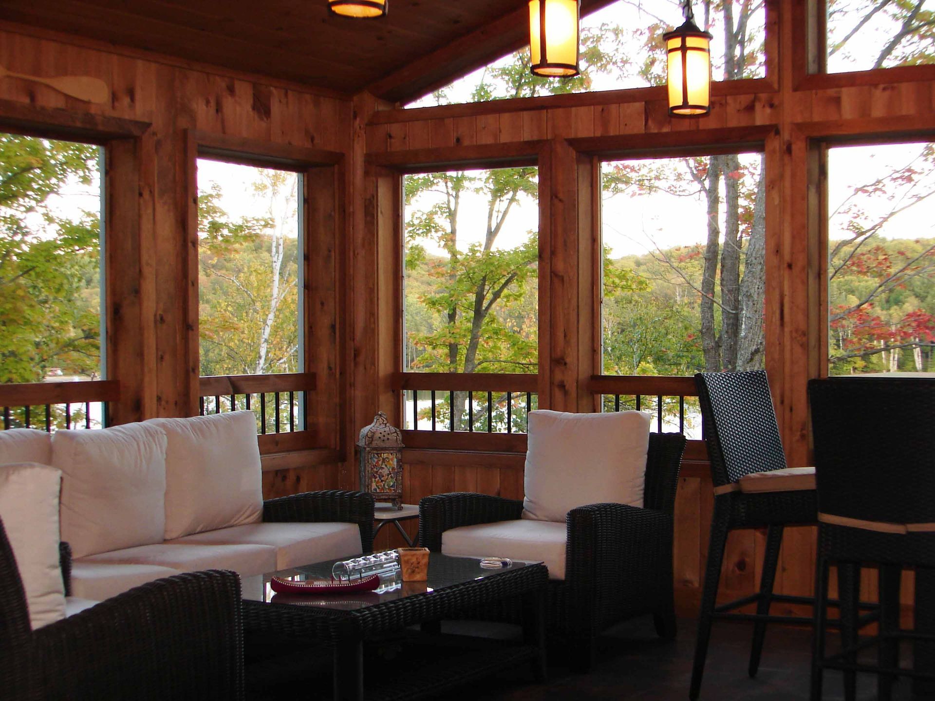A living room with a lot of windows and furniture