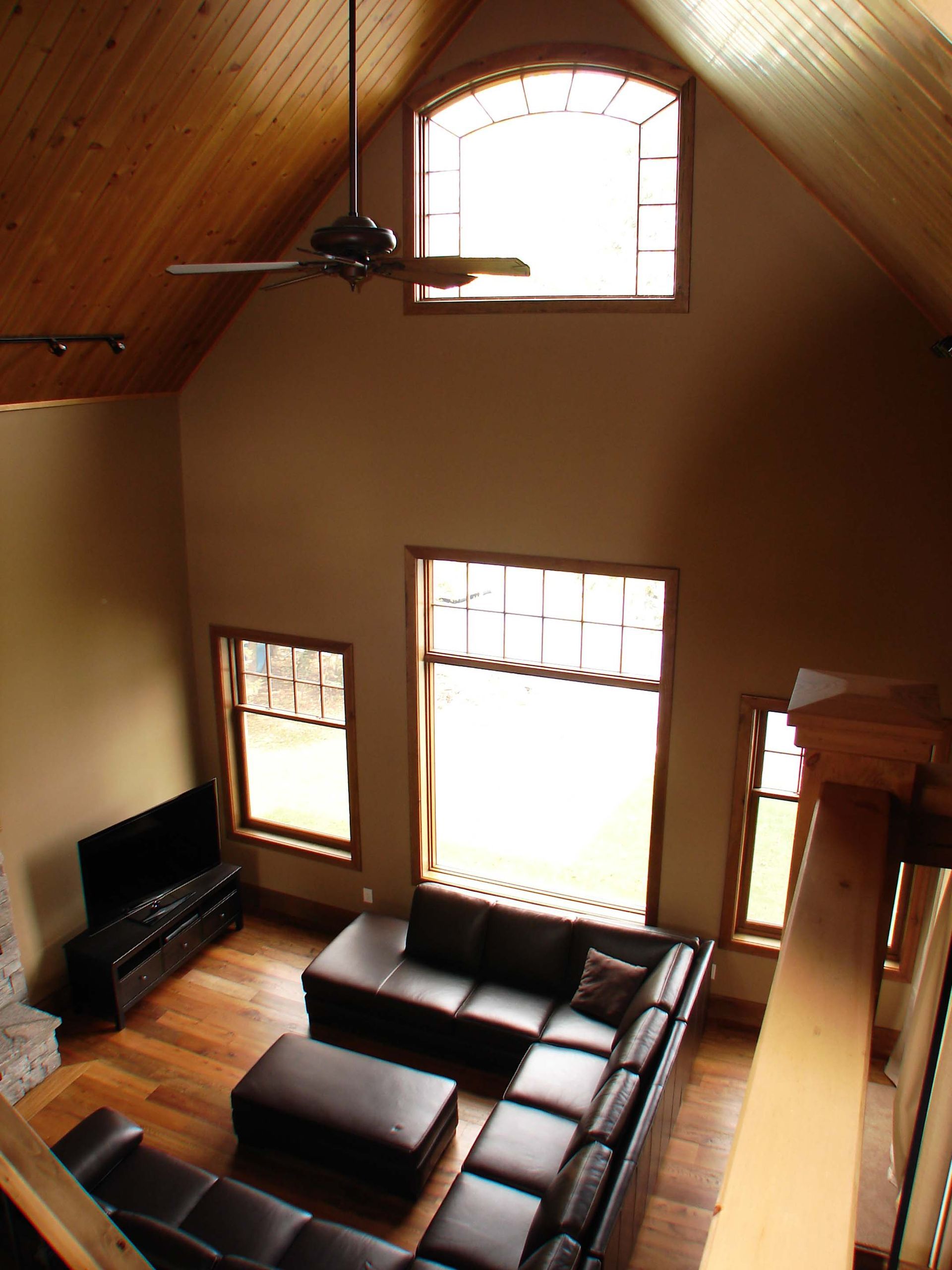 A living room with a couch and a ceiling fan
