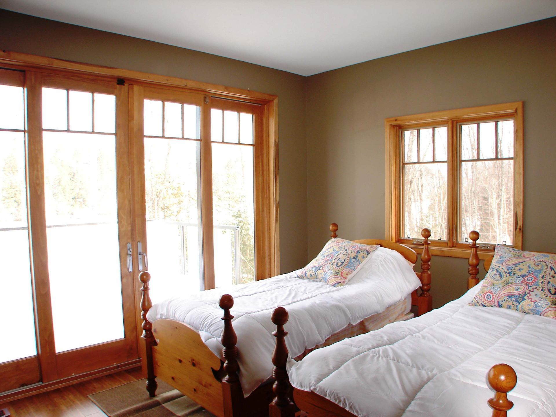 A bedroom with two twin beds and sliding glass doors