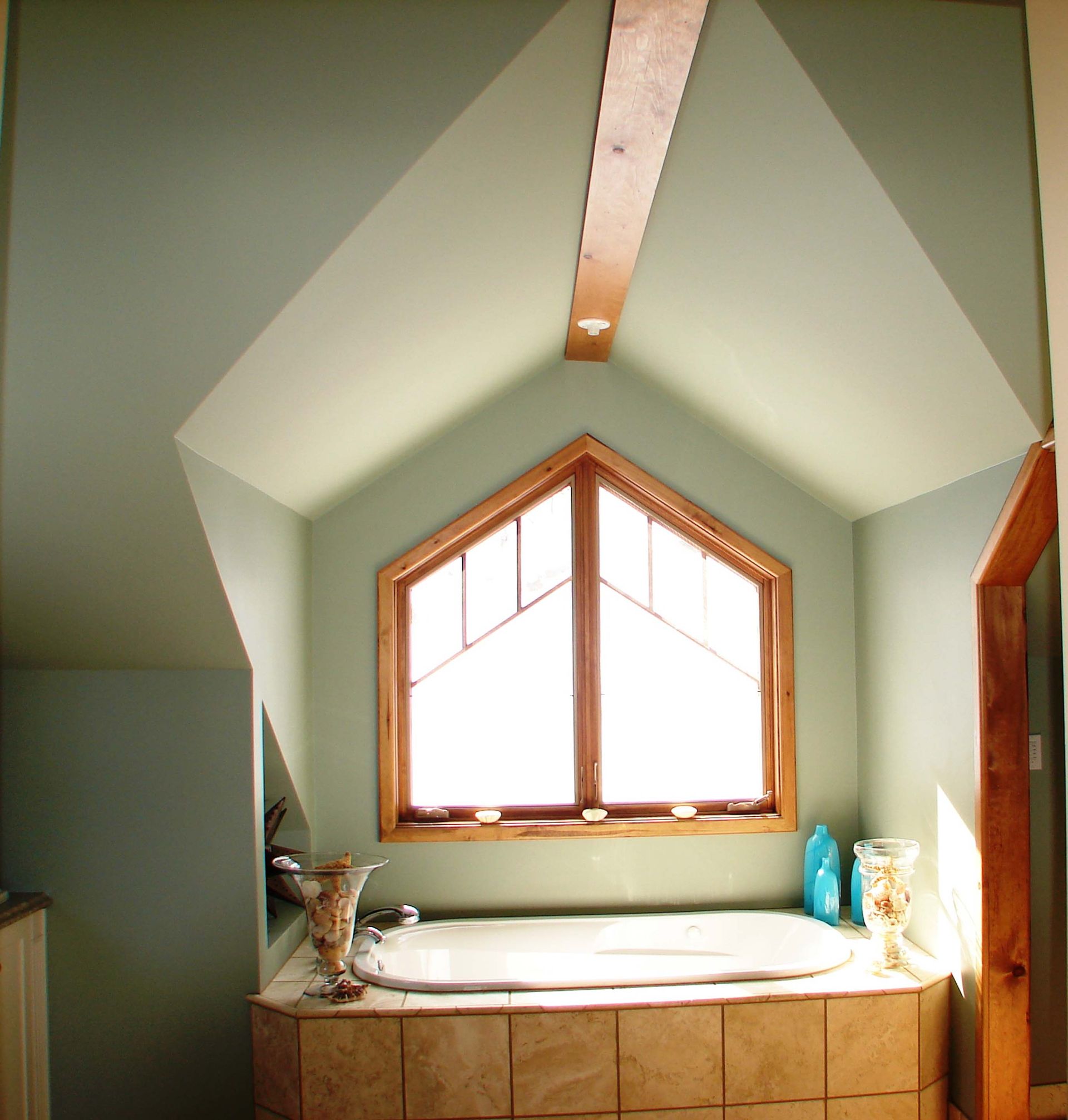 A bathroom with a large window and a bathtub