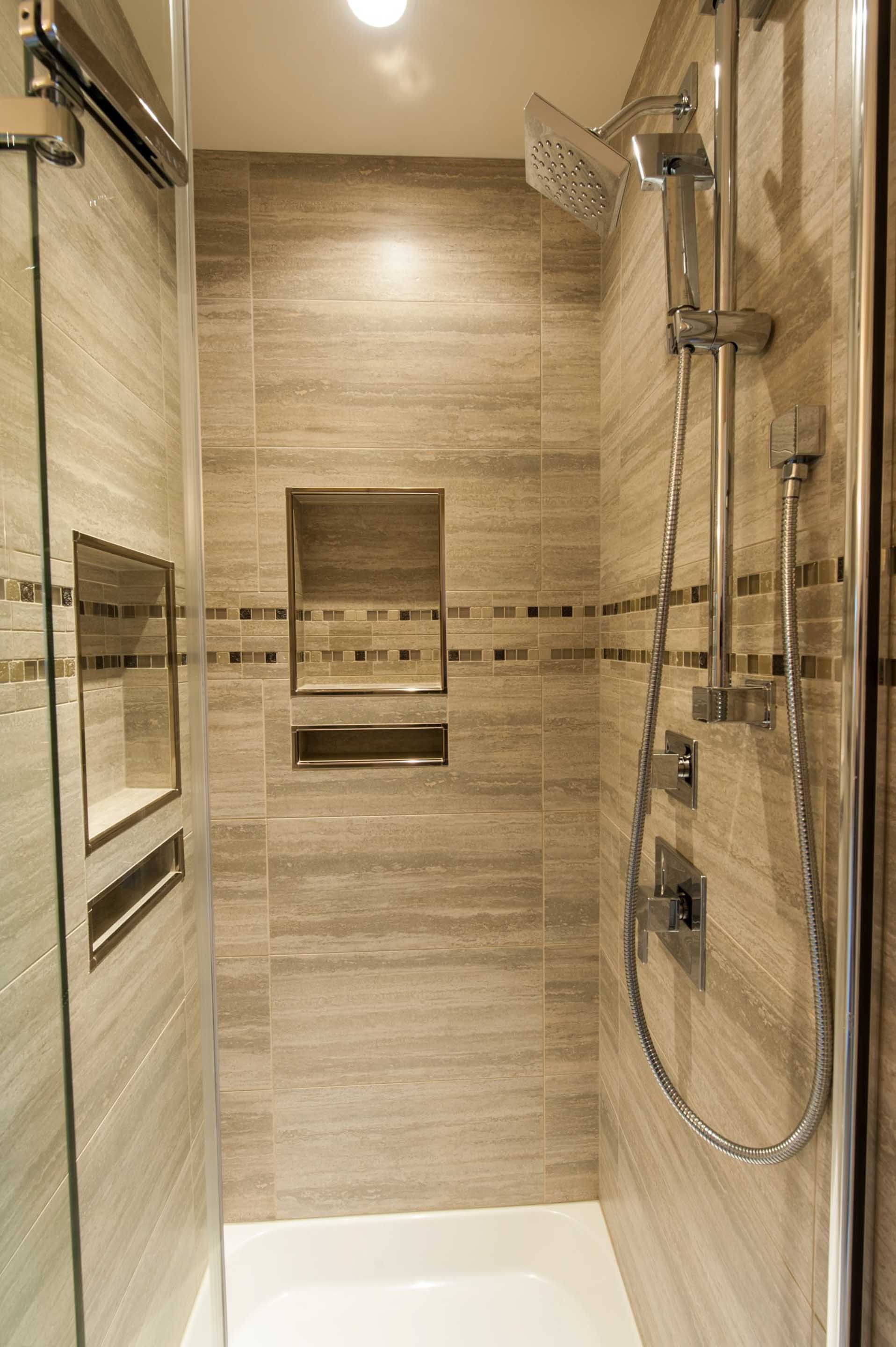 A shower with a sliding glass door and a shower head.