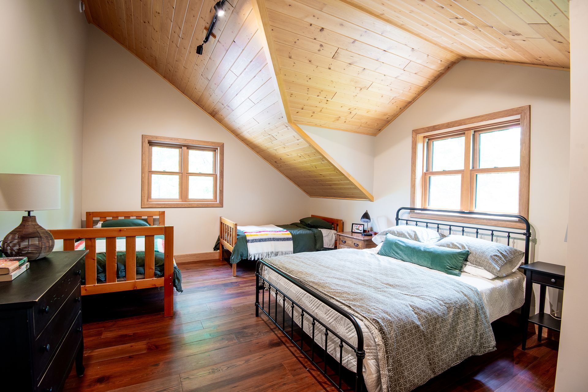 A bedroom with a king size bed and two twin beds.