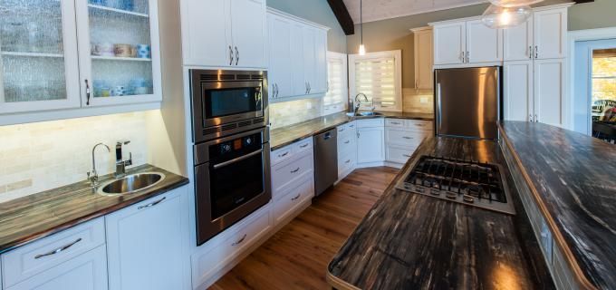 A kitchen with stainless steel appliances and granite counter tops.