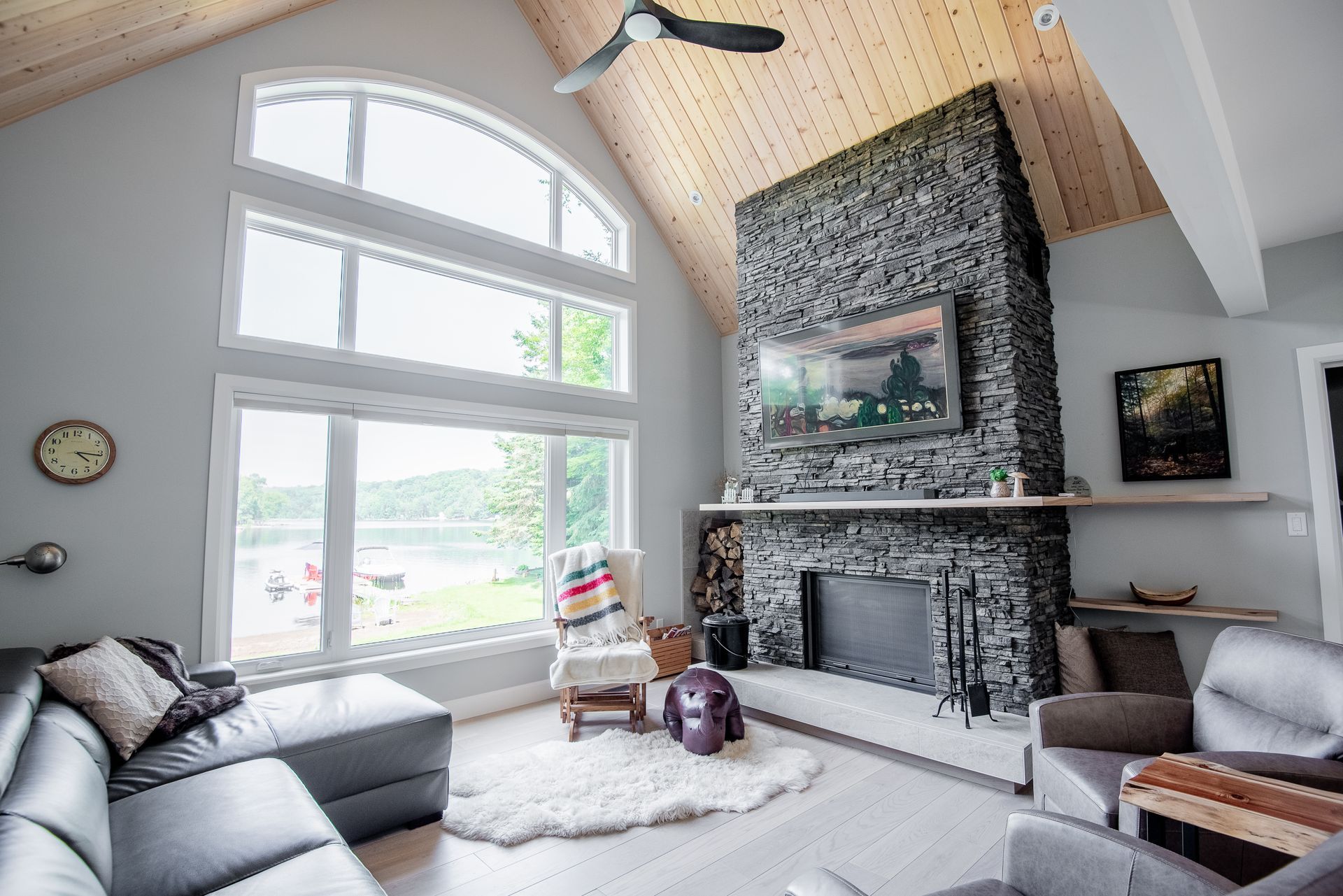 A living room with a fireplace , couch , chair and television.