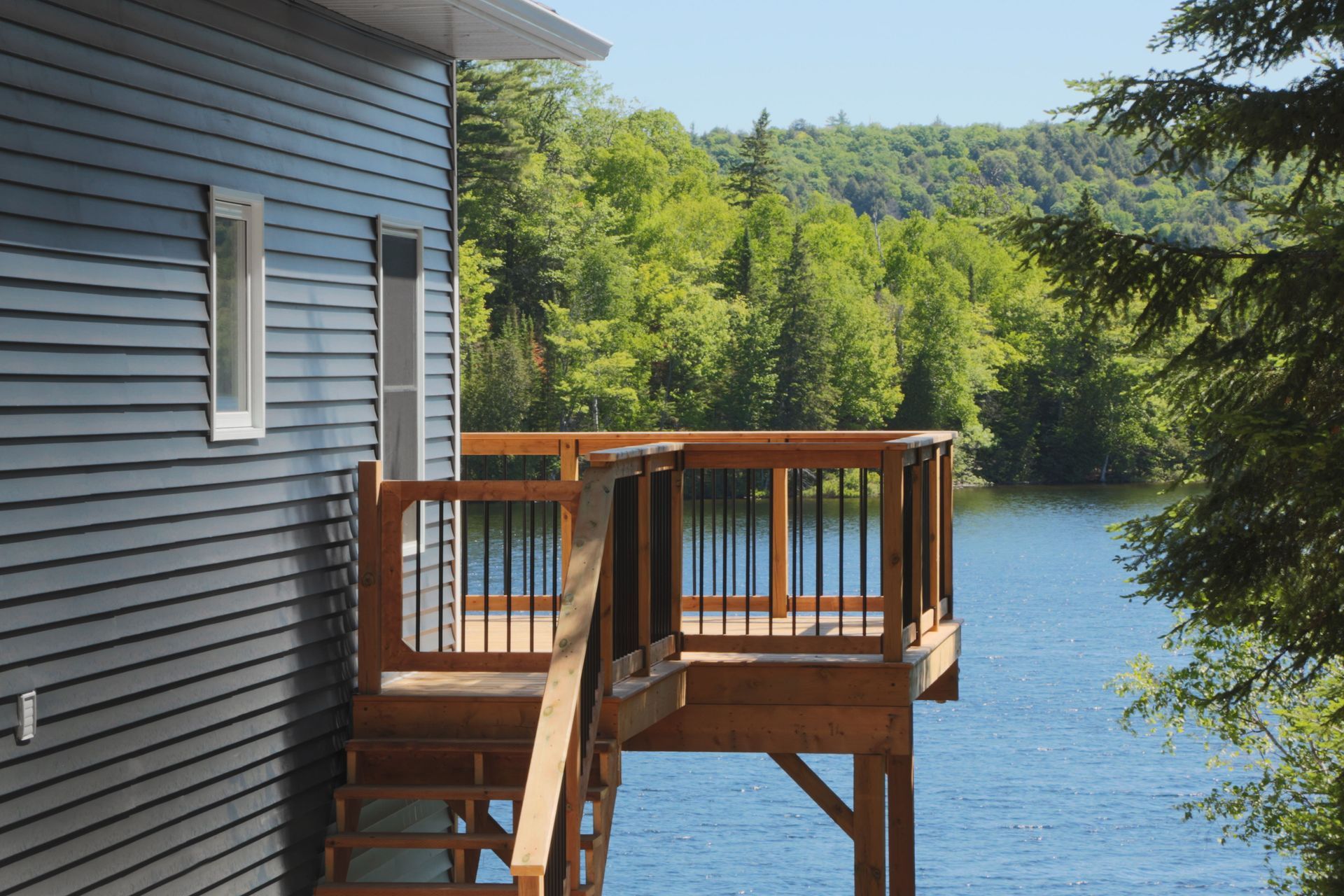 A house with a deck overlooking a lake