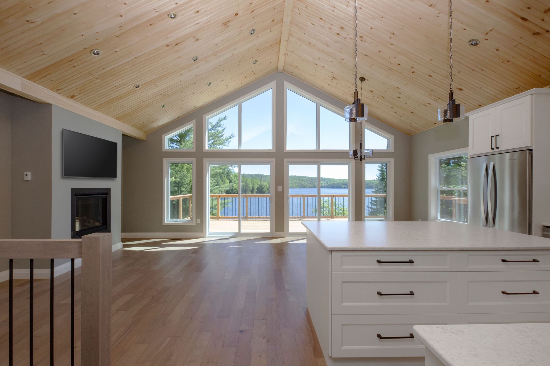 A kitchen with a lot of windows and a view of a lake.
