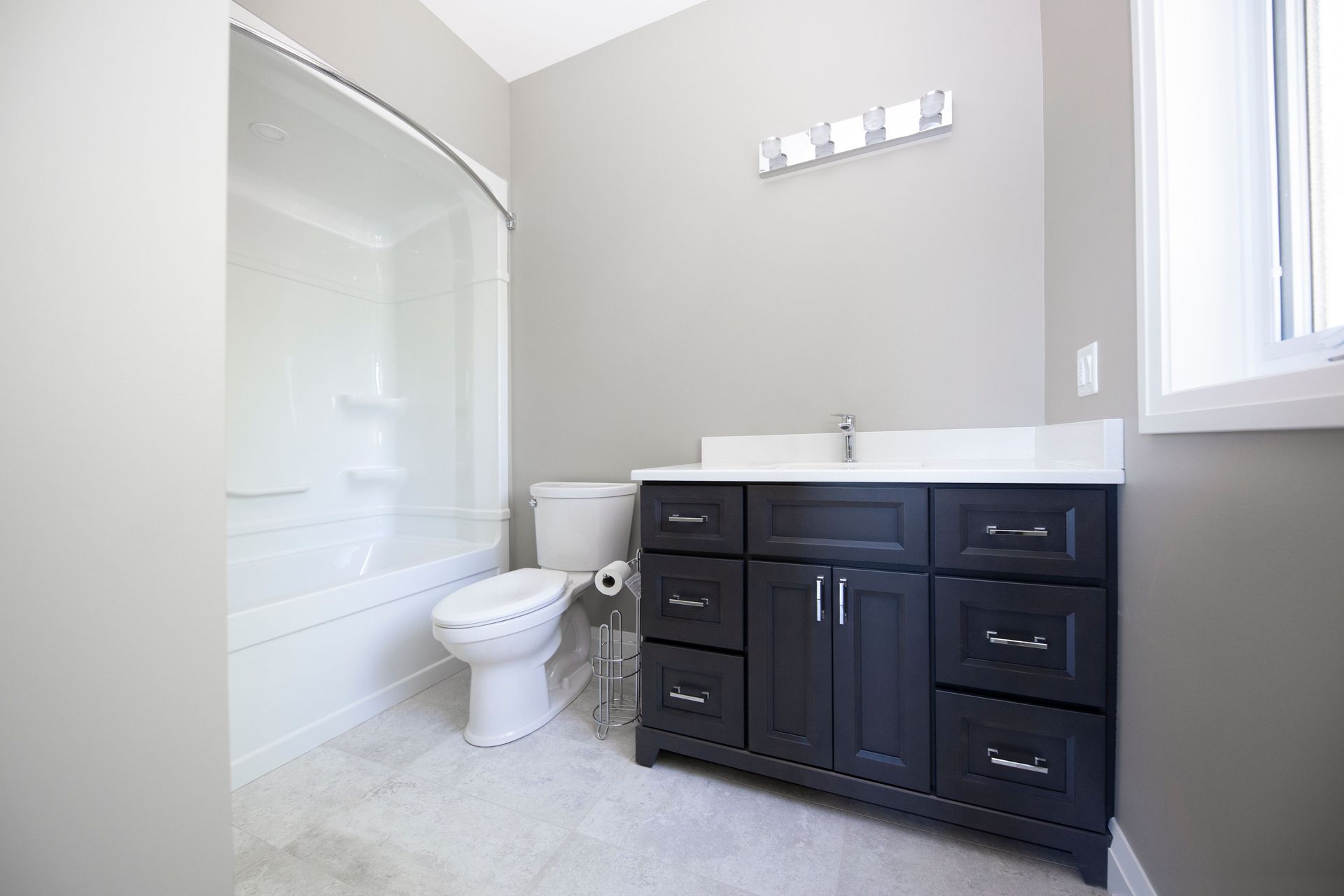 A bathroom with a toilet , sink , and bathtub.