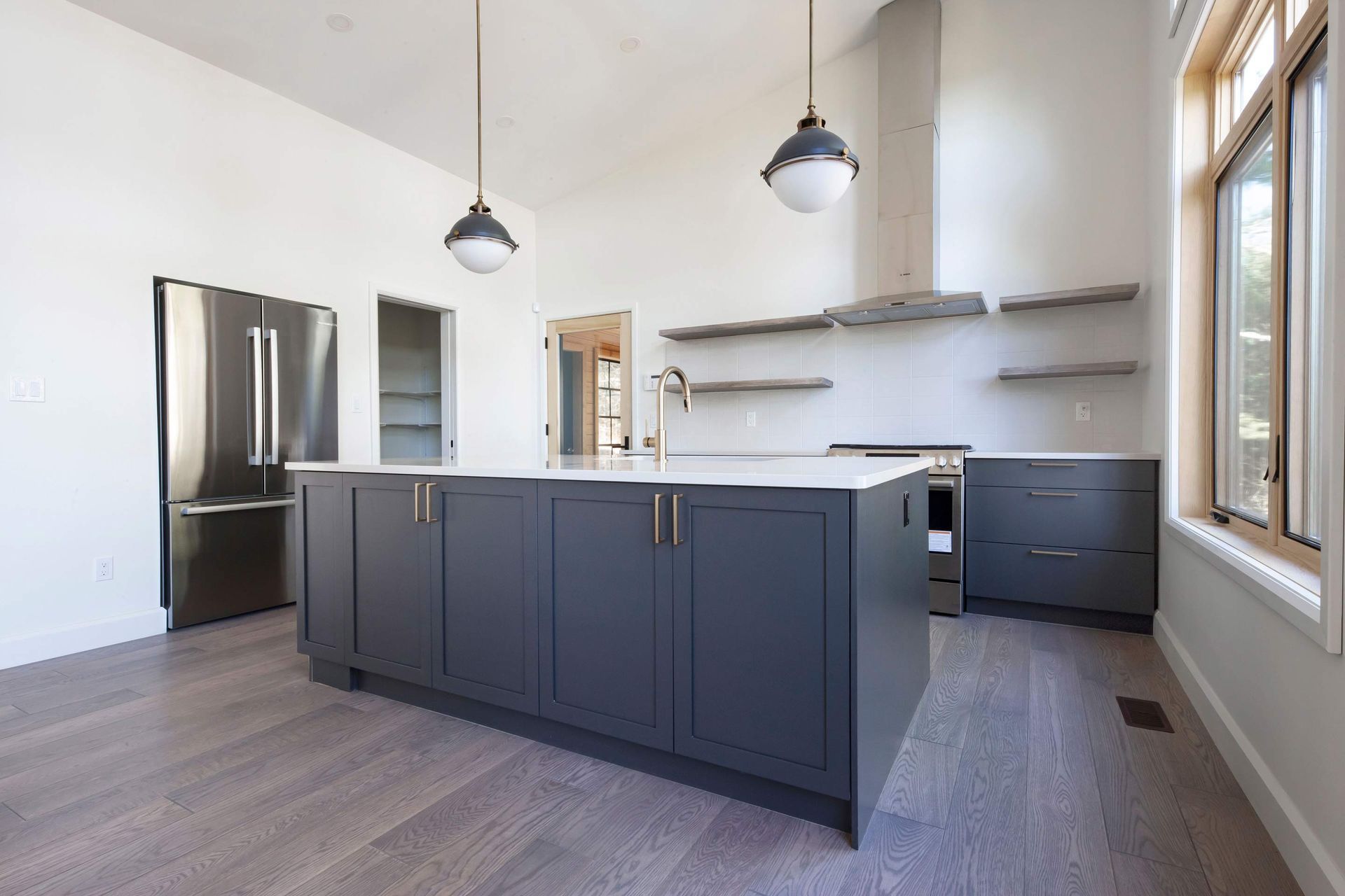 A kitchen with a large island and stainless steel appliances
