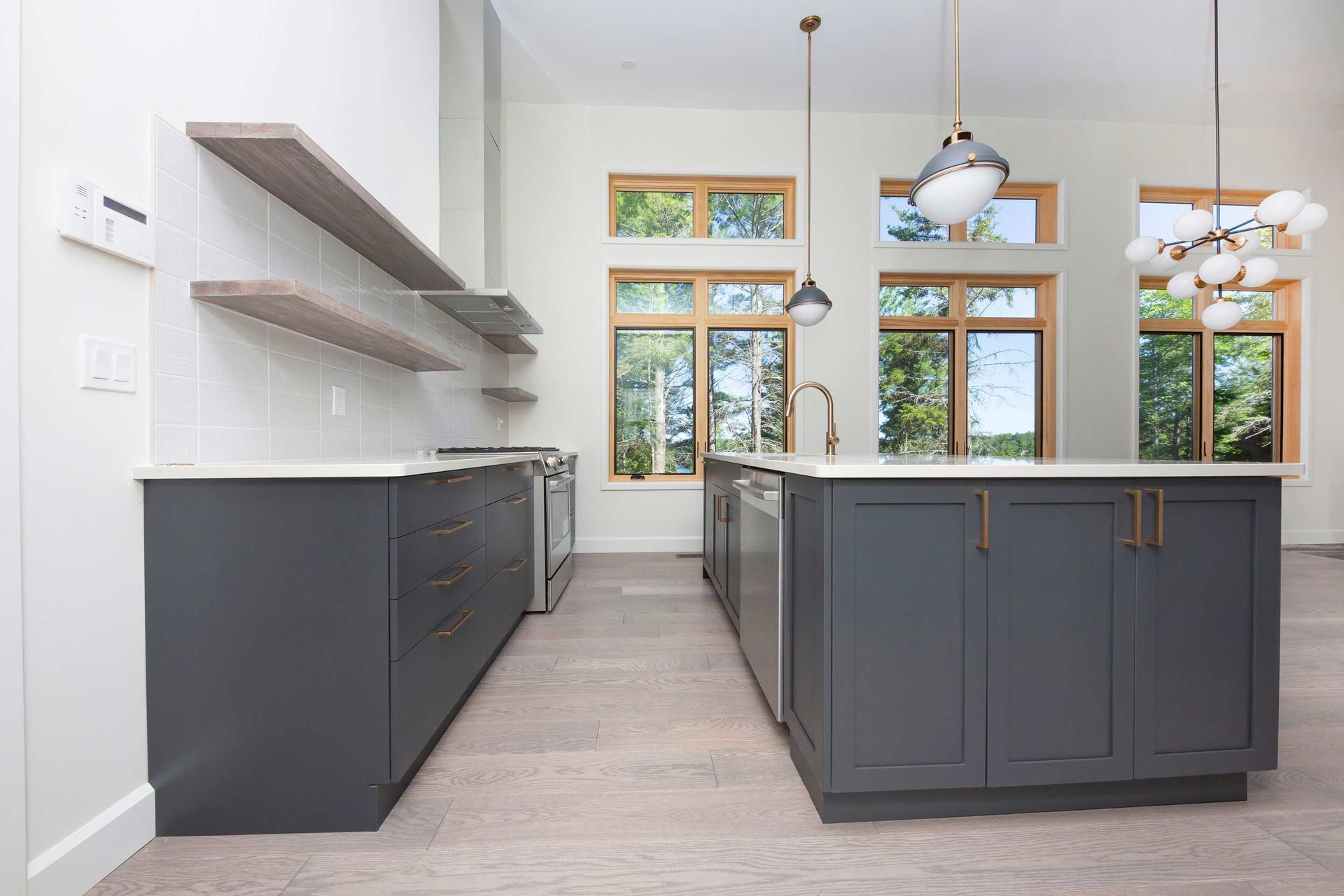 A kitchen with a large island and stainless steel appliances.