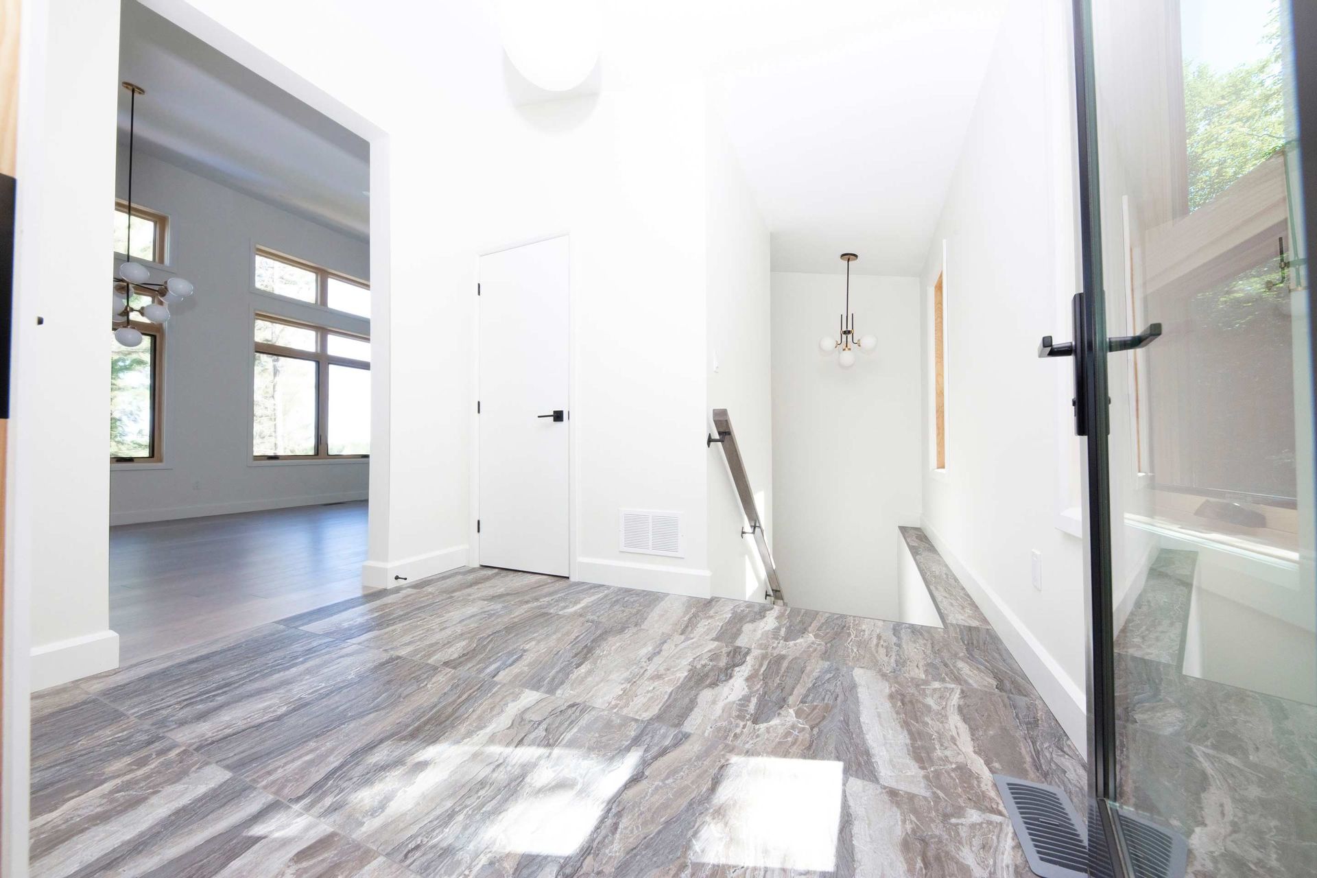 A hallway with a staircase leading up to the second floor of a house.