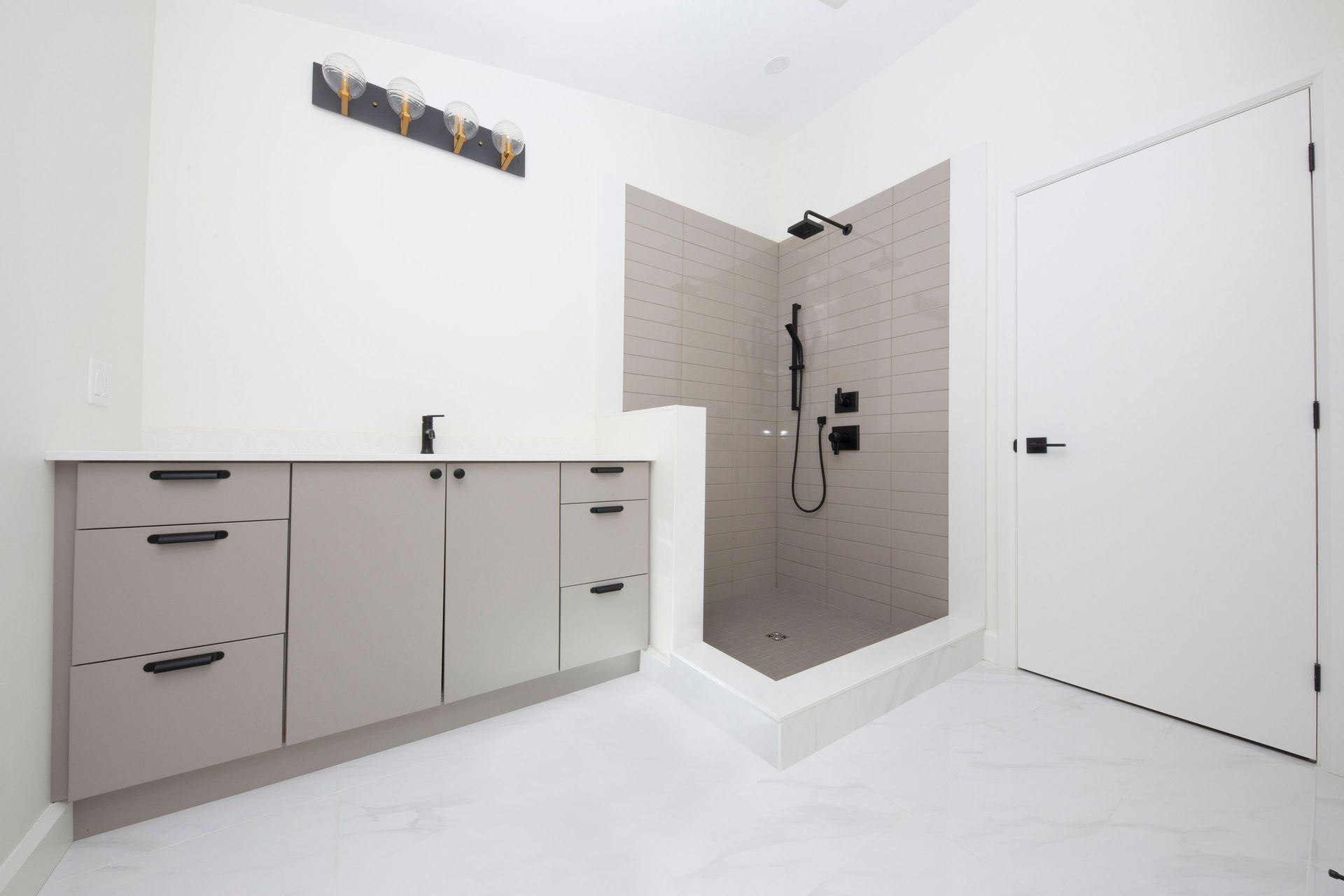 A bathroom with a walk in shower and a sink.