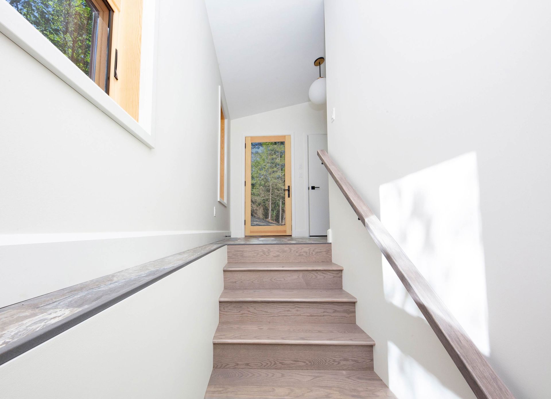 A set of stairs leading up to a door in a house.