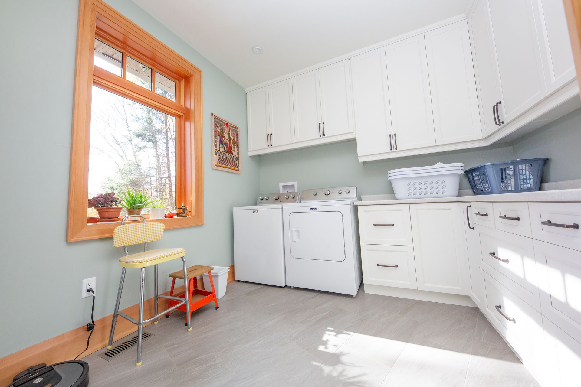 A laundry room with a washer and dryer and a window