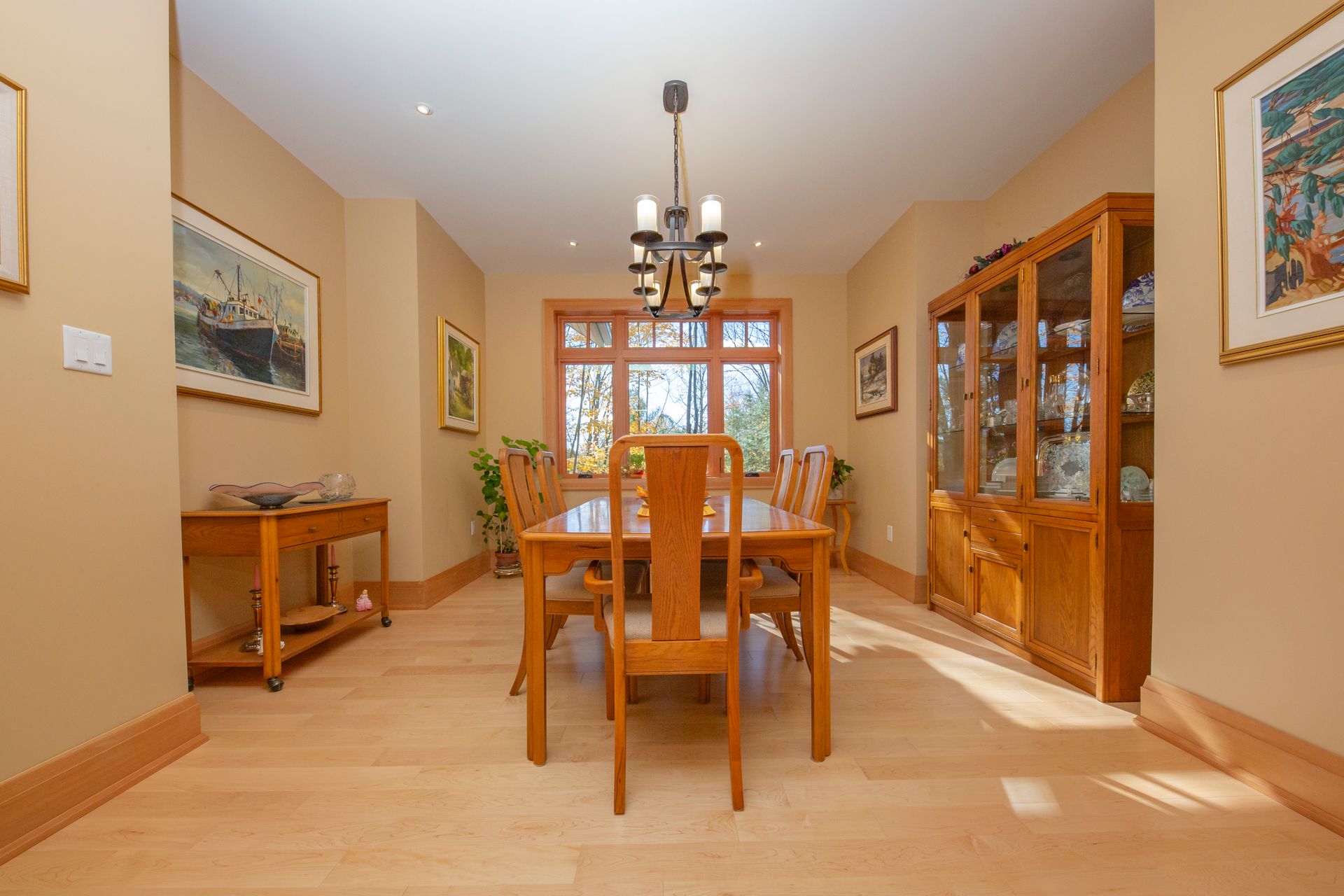 A dining room with a table and chairs and a chandelier.