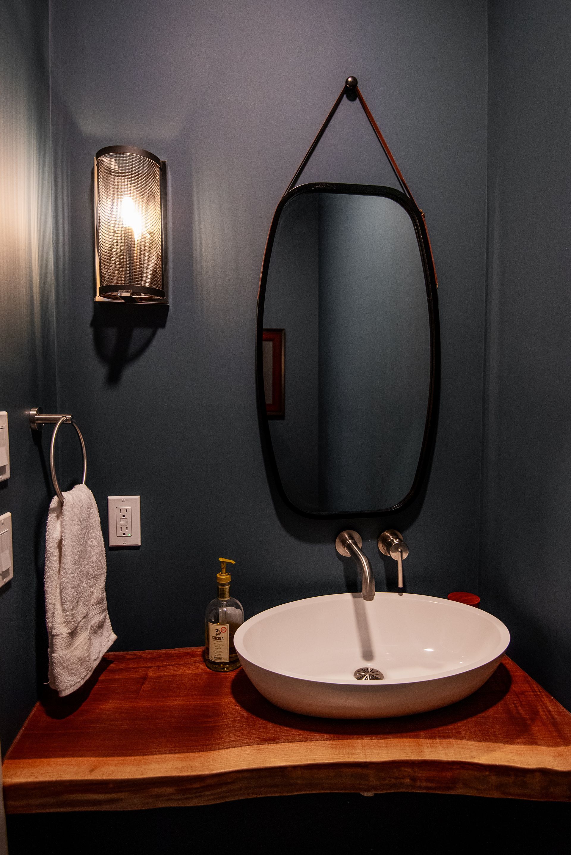 A bathroom with a sink and a mirror on the wall.