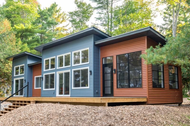 A blue and brown house with a lot of windows