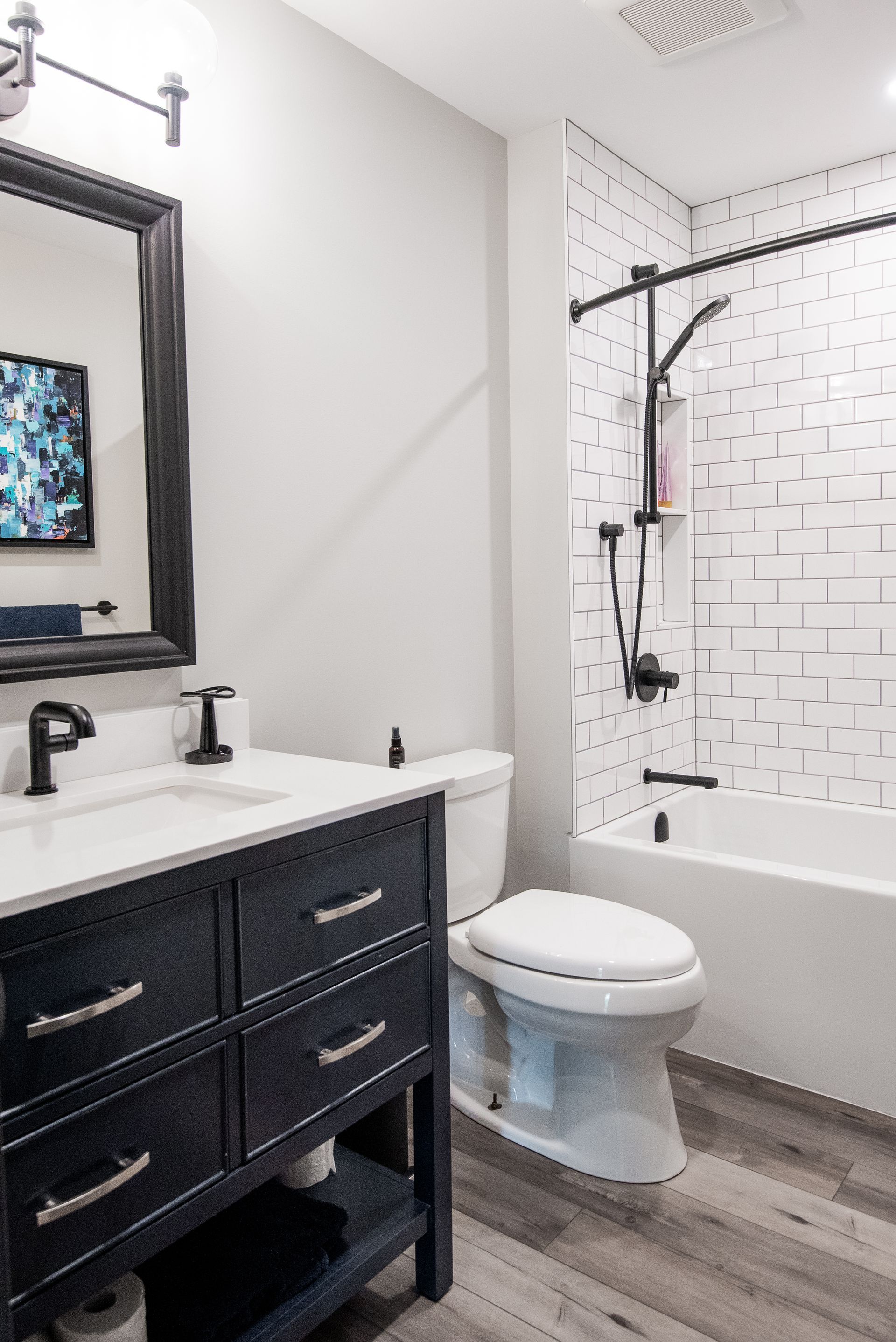 A bathroom with a toilet , sink , and bathtub.