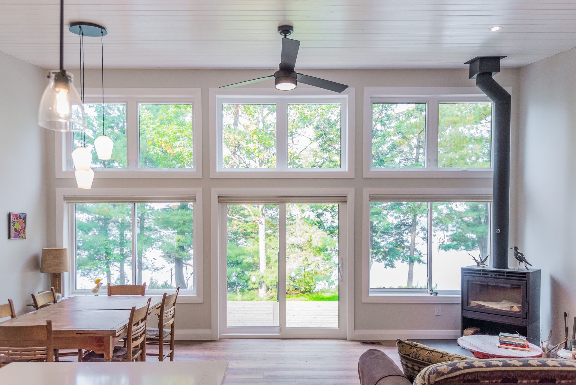 A living room with a lot of windows and a fireplace.
