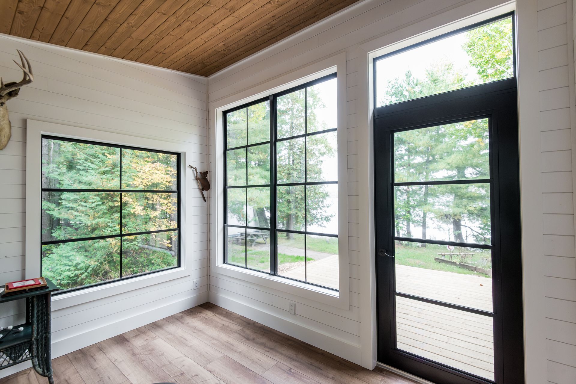 A room with a lot of windows and a door.