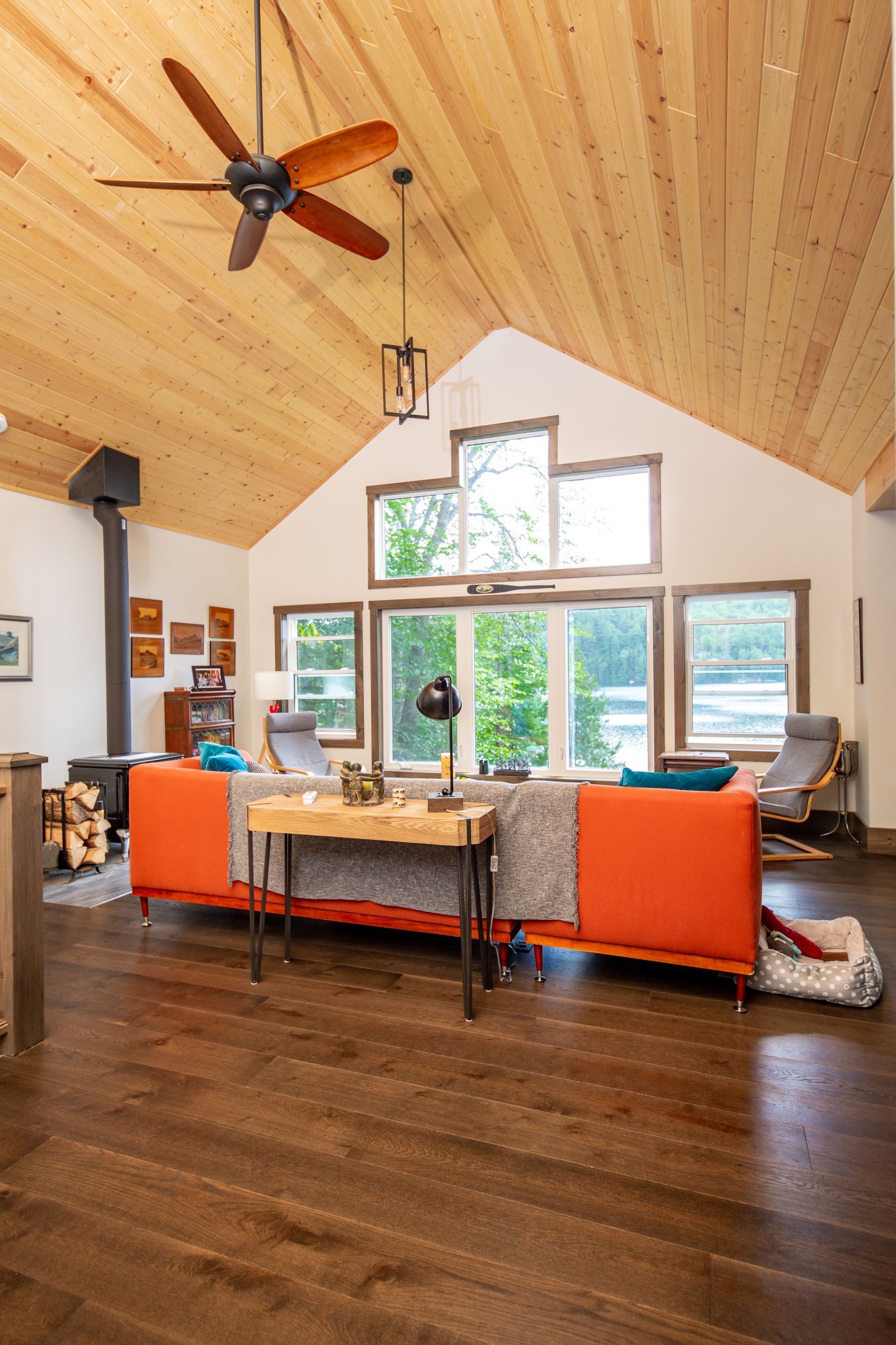 A living room with a vaulted ceiling and a ceiling fan.