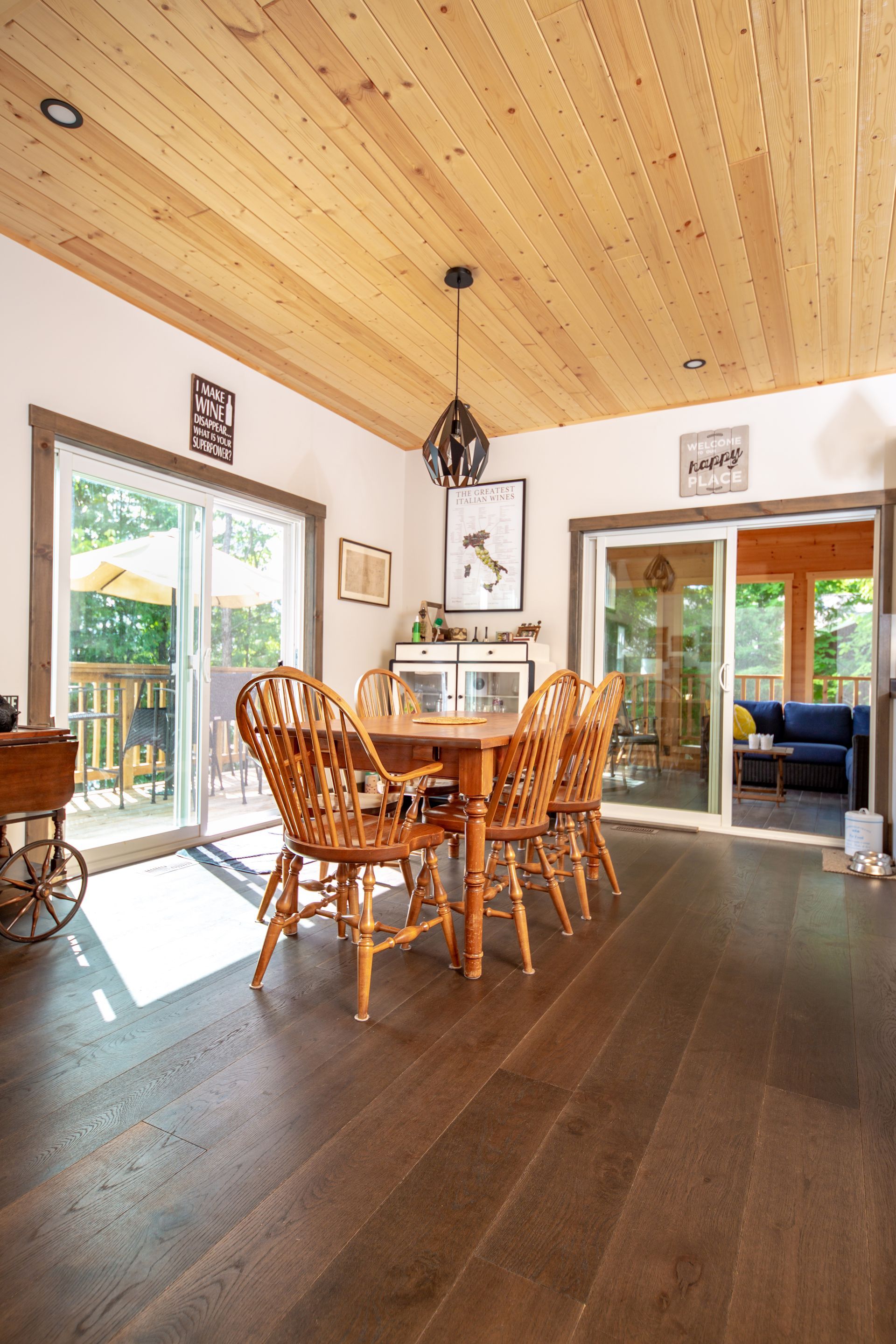A dining room with a table and chairs and a sliding glass door.
