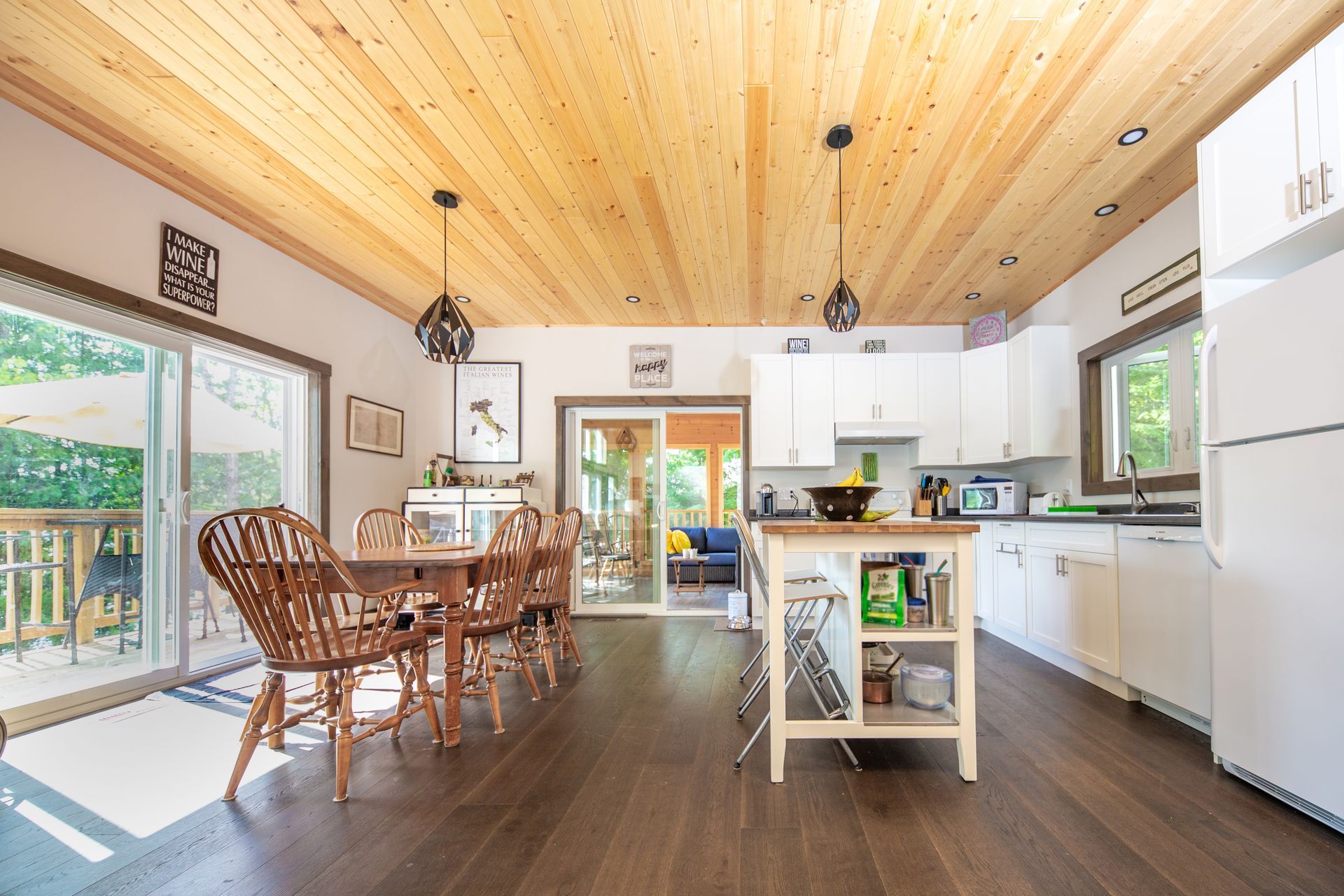 A kitchen with a wooden ceiling and white cabinets