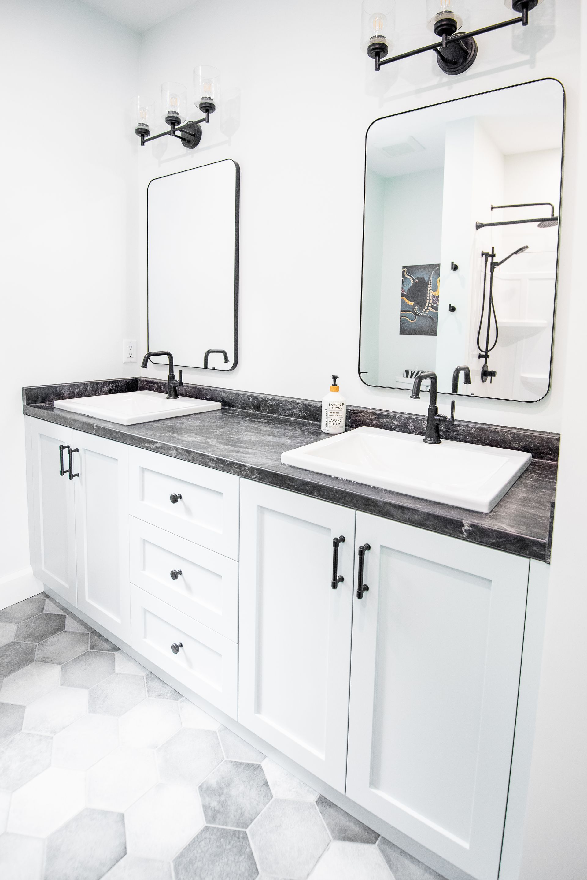 A bathroom with two sinks and two mirrors.